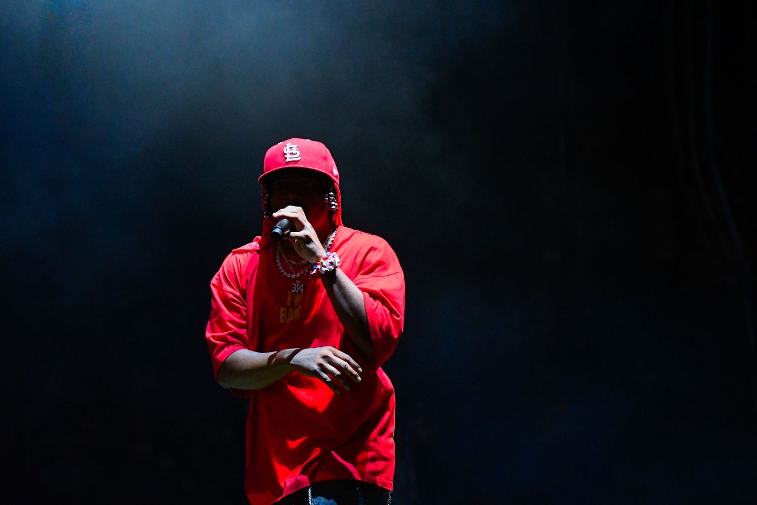 Seven sequential photos show a person in a red hoodie performing dance moves against a dark background.