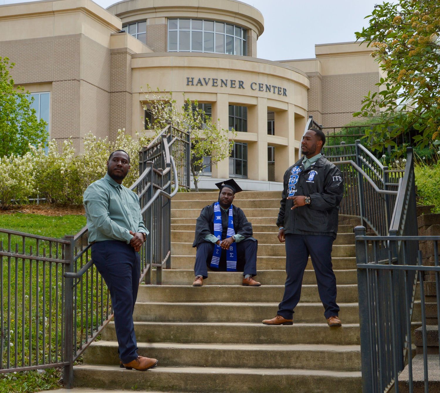 Students stand on the steps of the Gardner Center building during a sunny day on campus.
