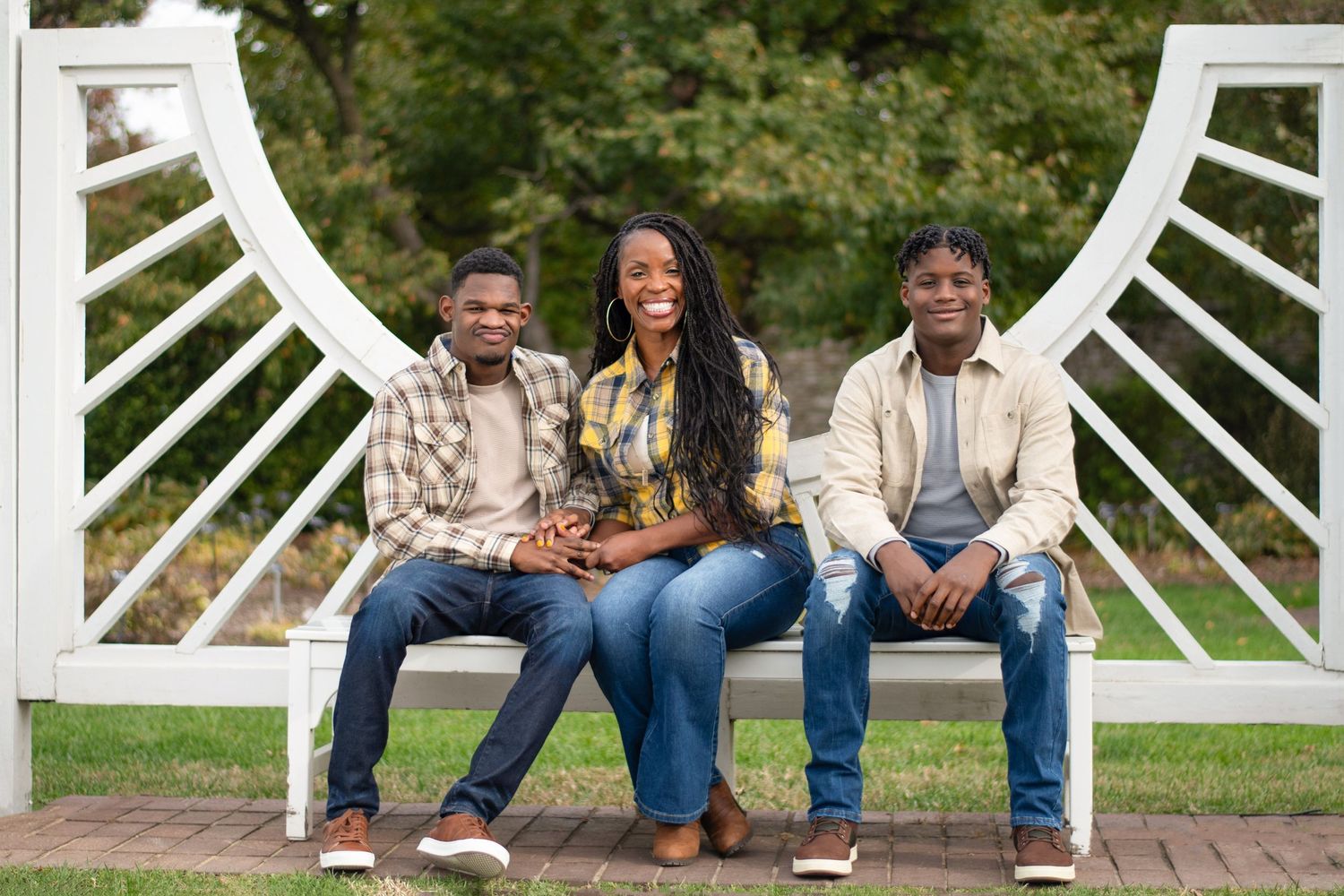 Group photo session on white garden benches outdoors during autumn.