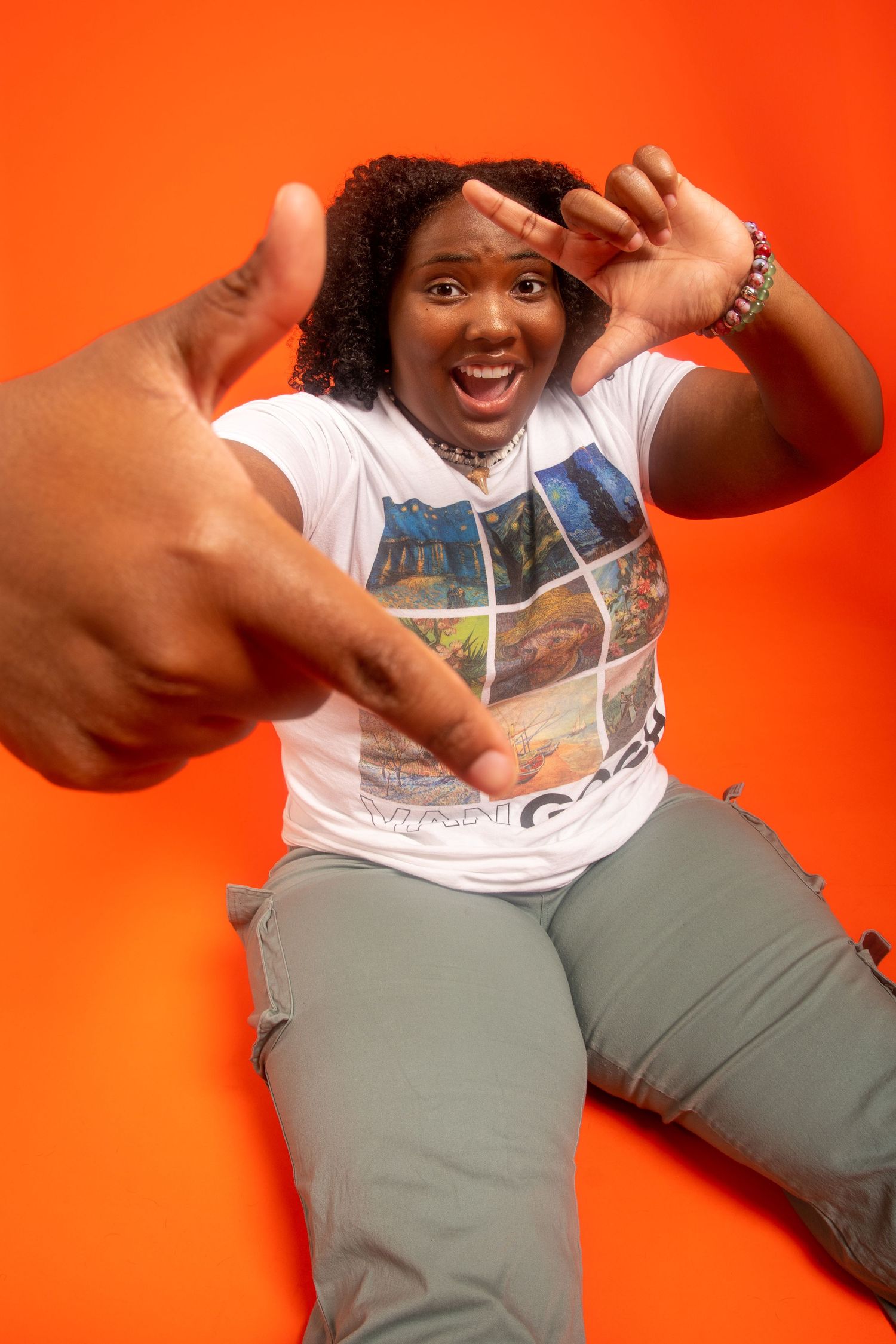 Person in white t-shirt and olive pants makes dynamic poses against bright orange background in sequential photos.