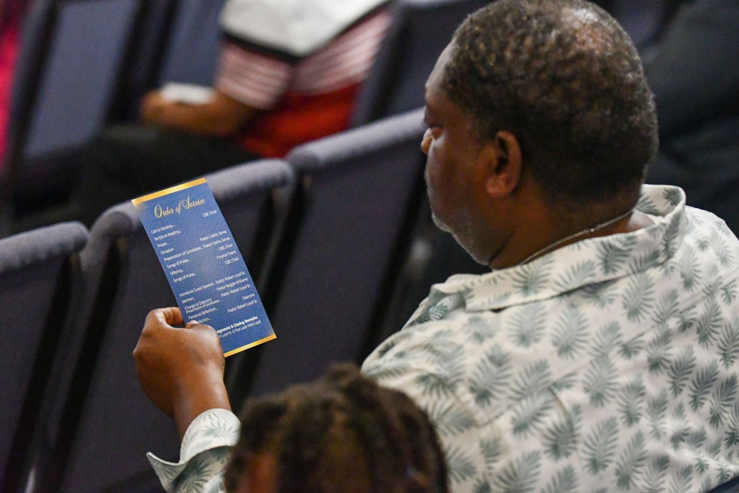 Military service members review documents and paperwork during a training session at a desk.