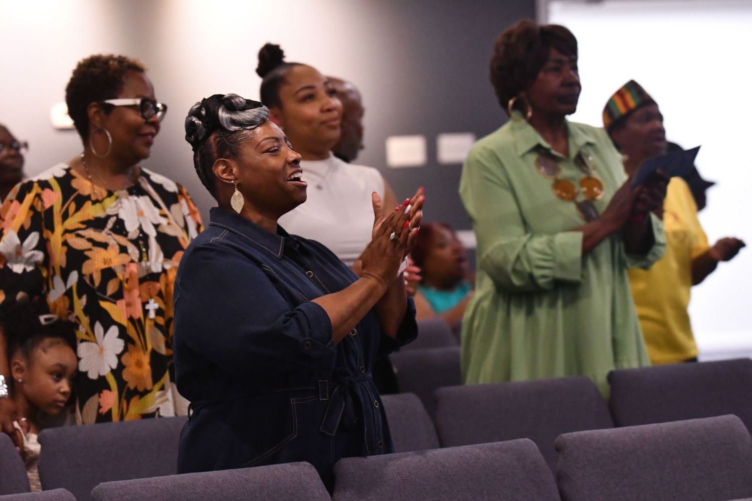 People worship and raise their hands during an emotional church service gathering.