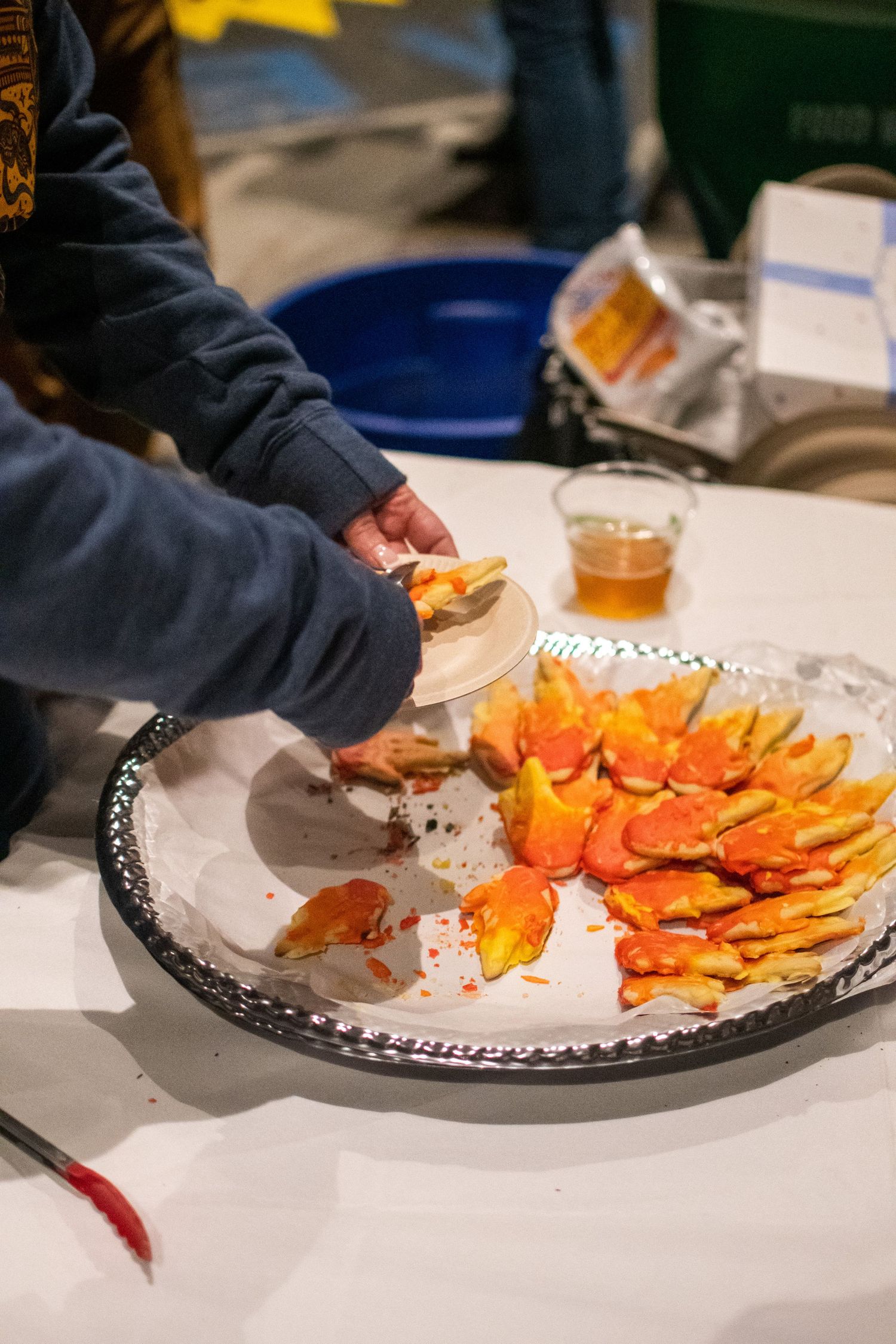 A series of photos showing hands arranging bright orange sliced carrots on a decorative white serving platter.