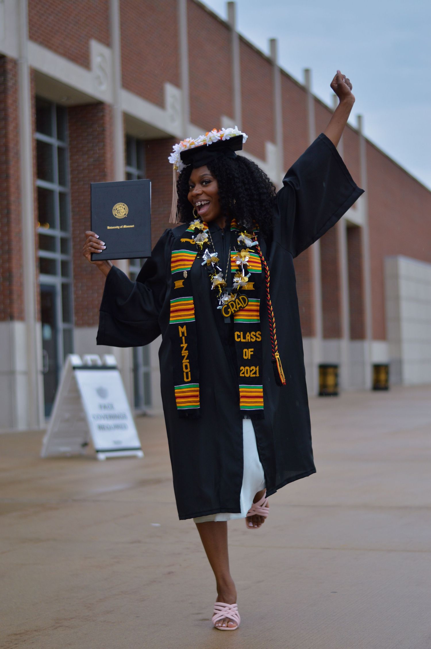 Graduate in black cap and gown with kente stole celebrates commencement with dynamic photo sequence at university.