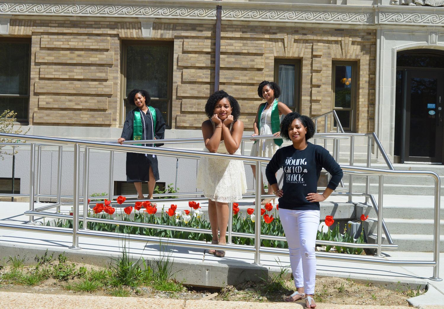 graduation portrait of black girl in front of building cloned four times wearing different outfits