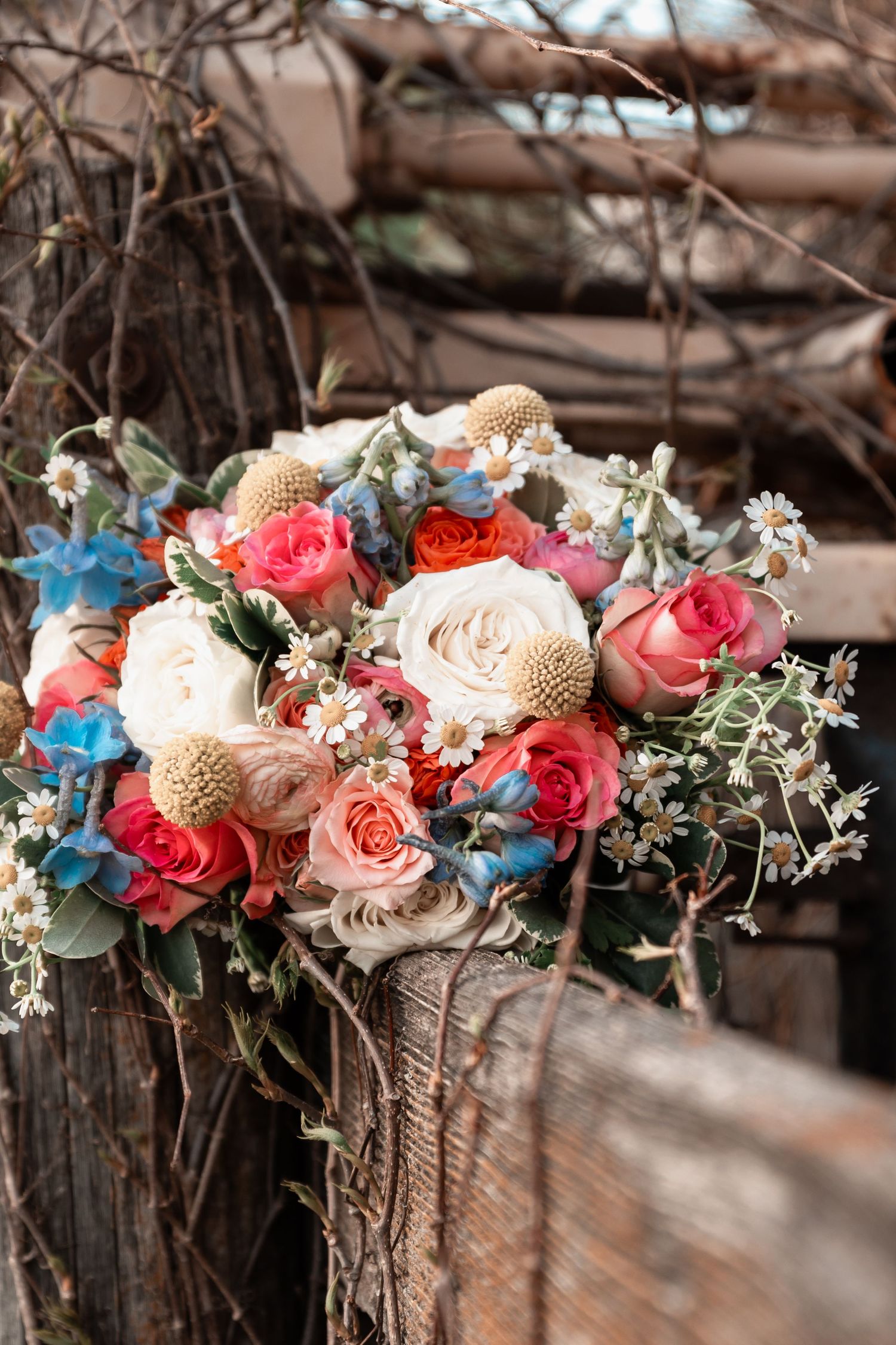 Rustic bridal bouquet featuring wildflowers and greenery with natural texture and earthy tones