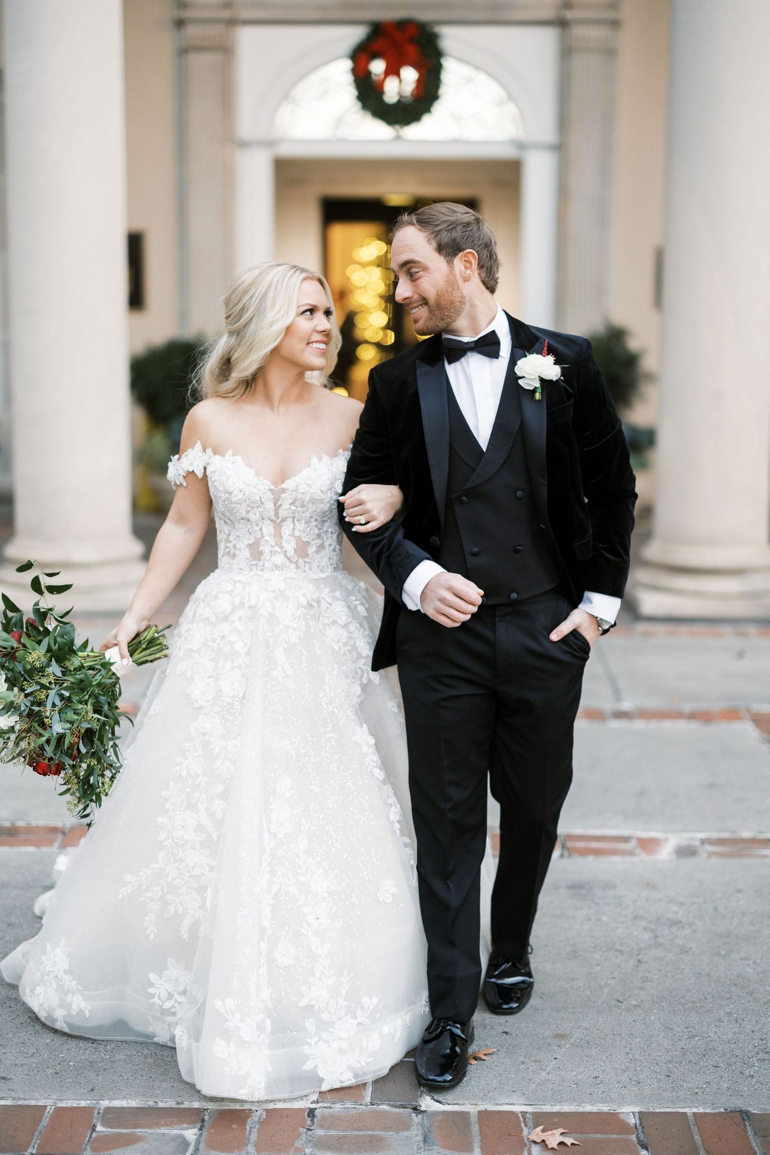Bride with blonde hair in lace wedding gown with her groom in black tuxedo at Biltmore Ballrooms in Atlanta
