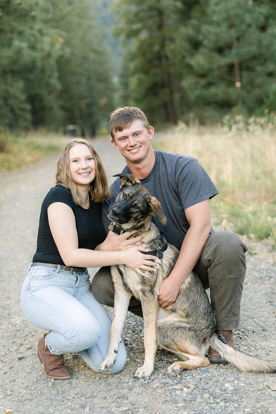 Family photos with their German Shepherd dog on a mountain trail.