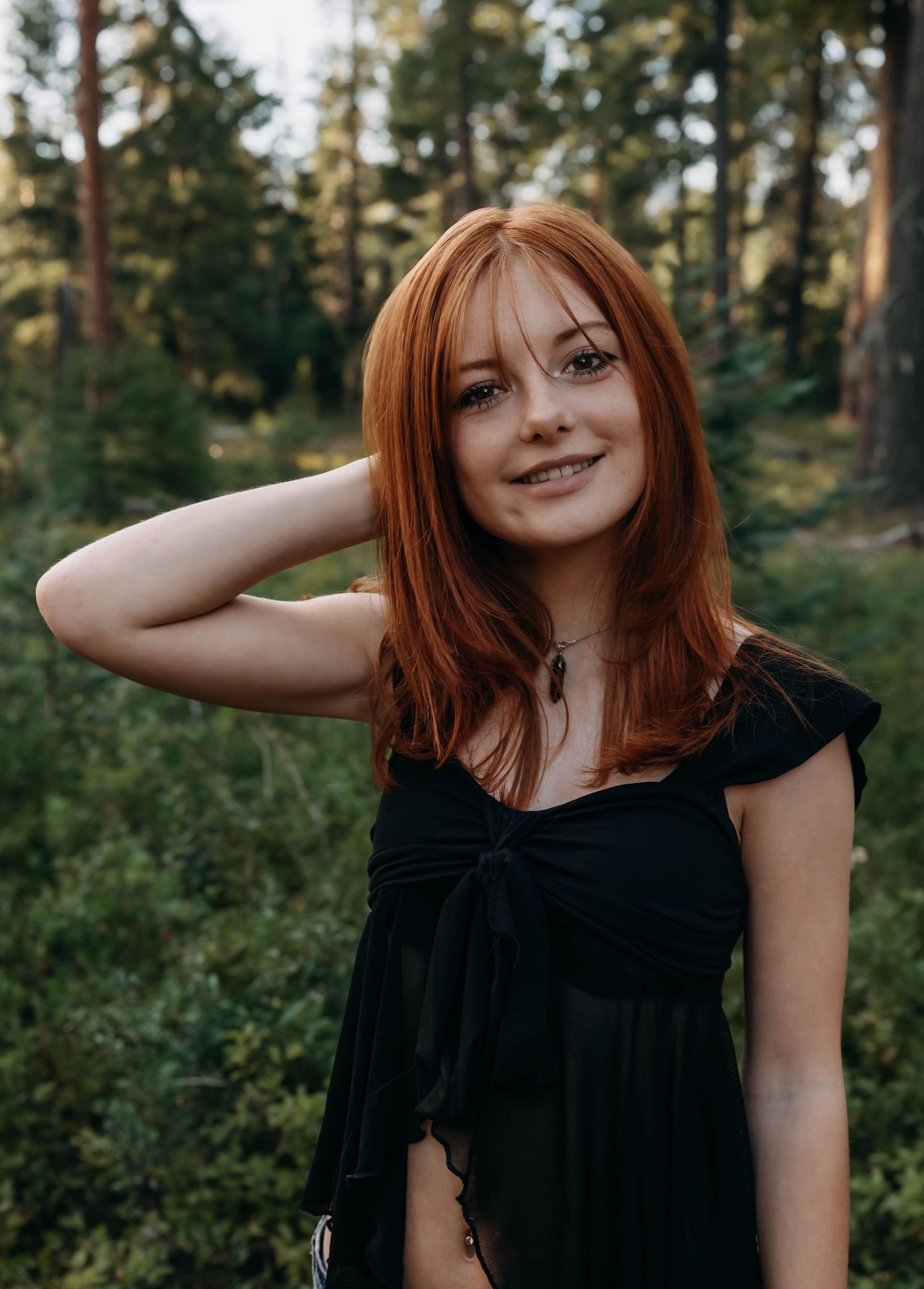 Playful portrait series in a sunlit forest setting.
