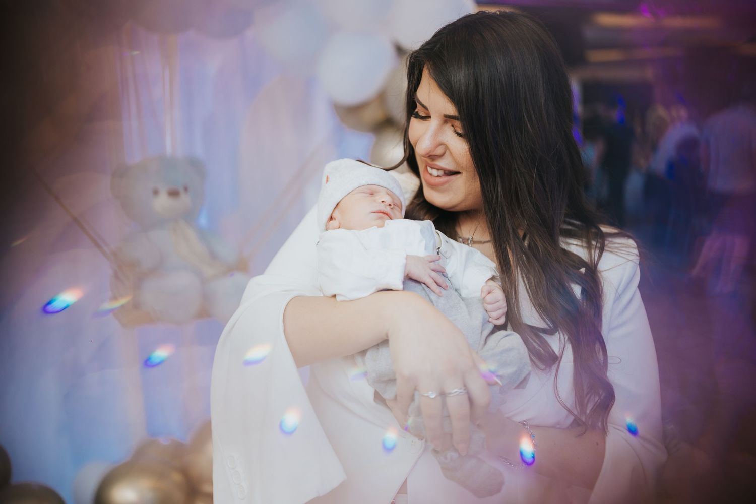 Baby celebration event with dreamy lighting effects and soft focus decorative elements.
