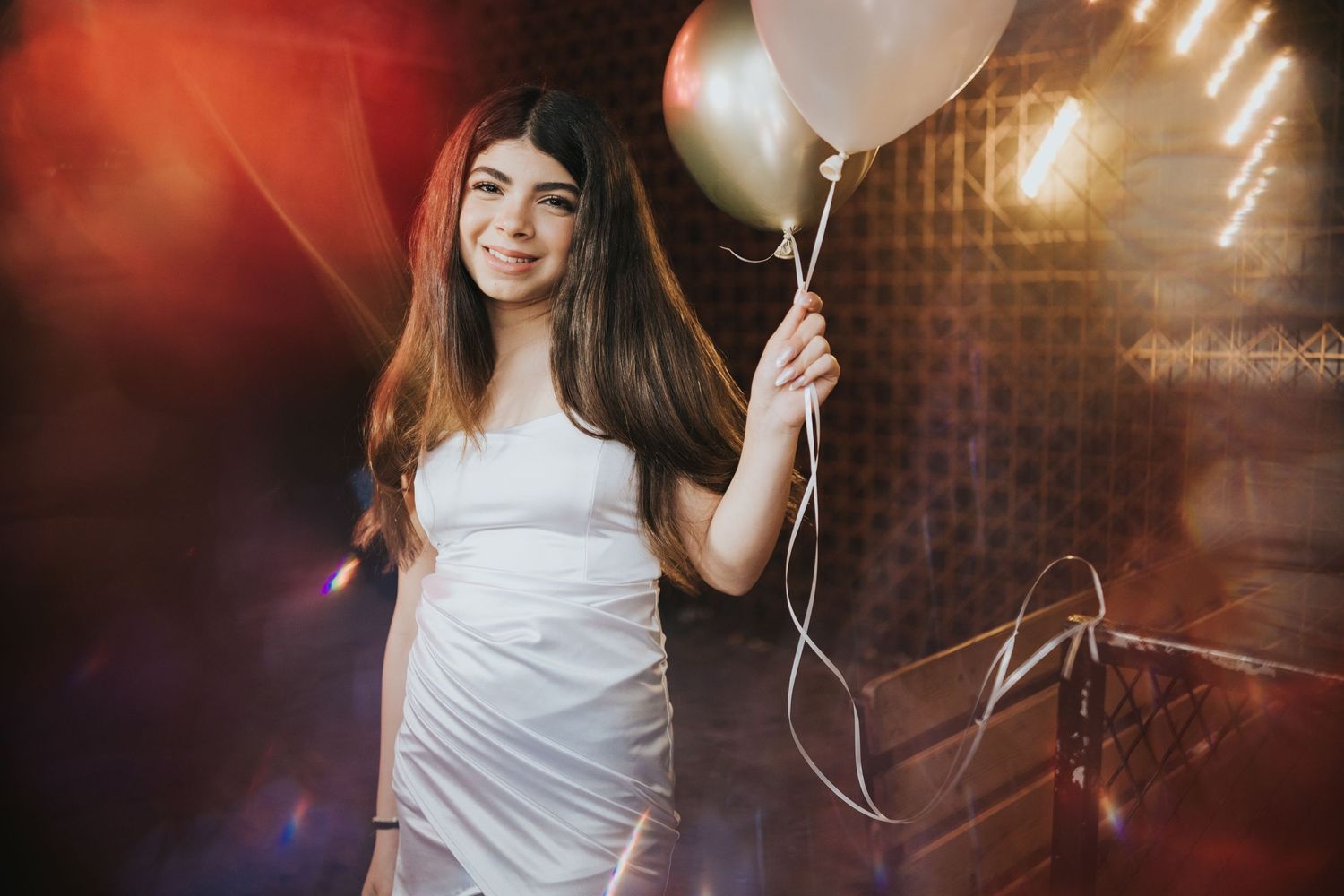 Moody party scene with white balloon and dramatic red lighting effects.