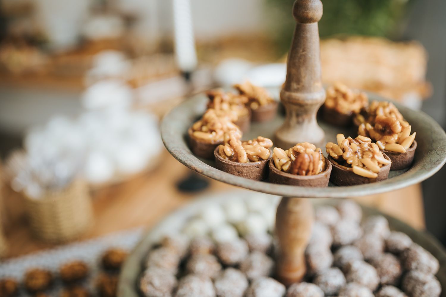 Close-up of bite-sized pastries displayed on a tiered serving plate.