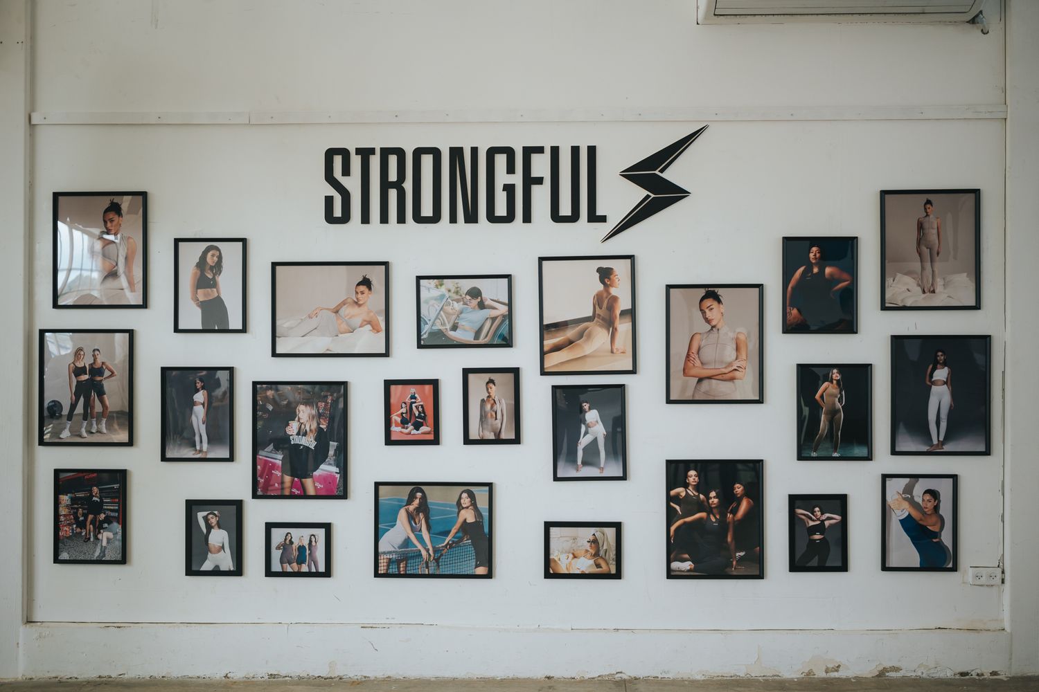 Gallery wall featuring multiple portrait photographs under Strongful brand logo on white background.