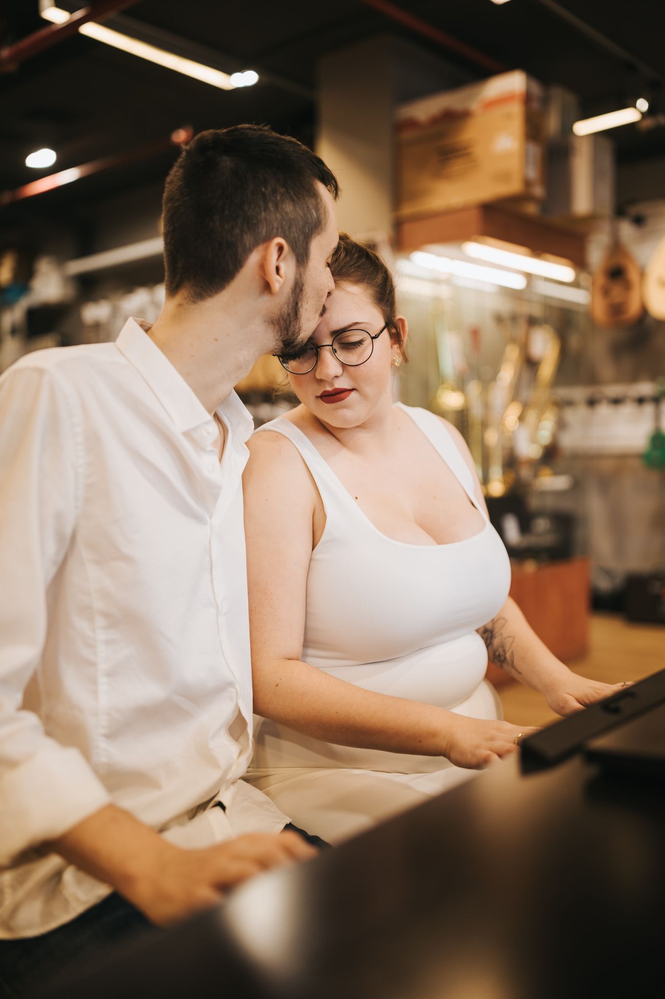 Couple reviewing menu together at restaurant counter in intimate setting.
