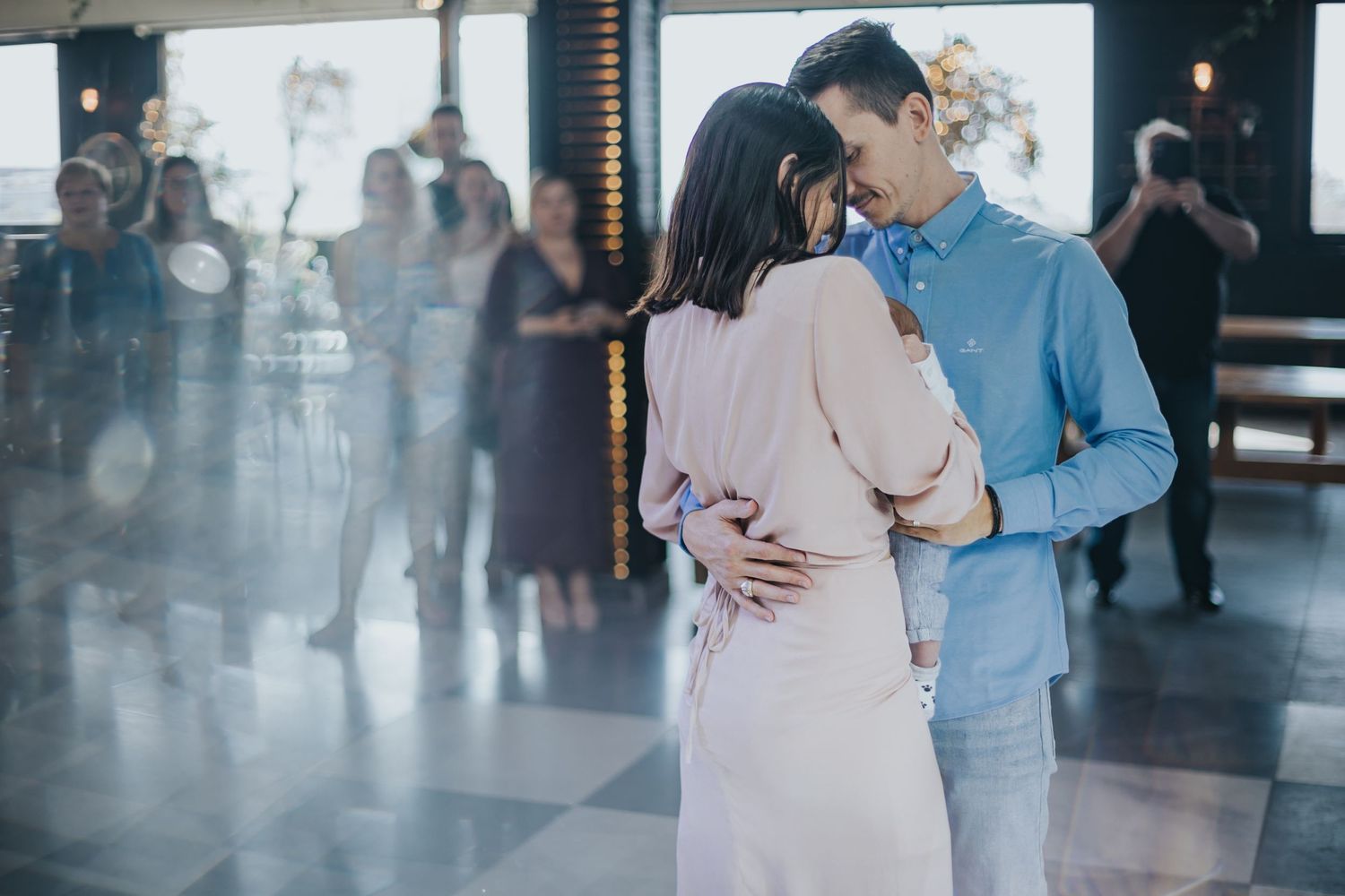 Couple sharing an intimate dance moment in formal attire at event venue.
