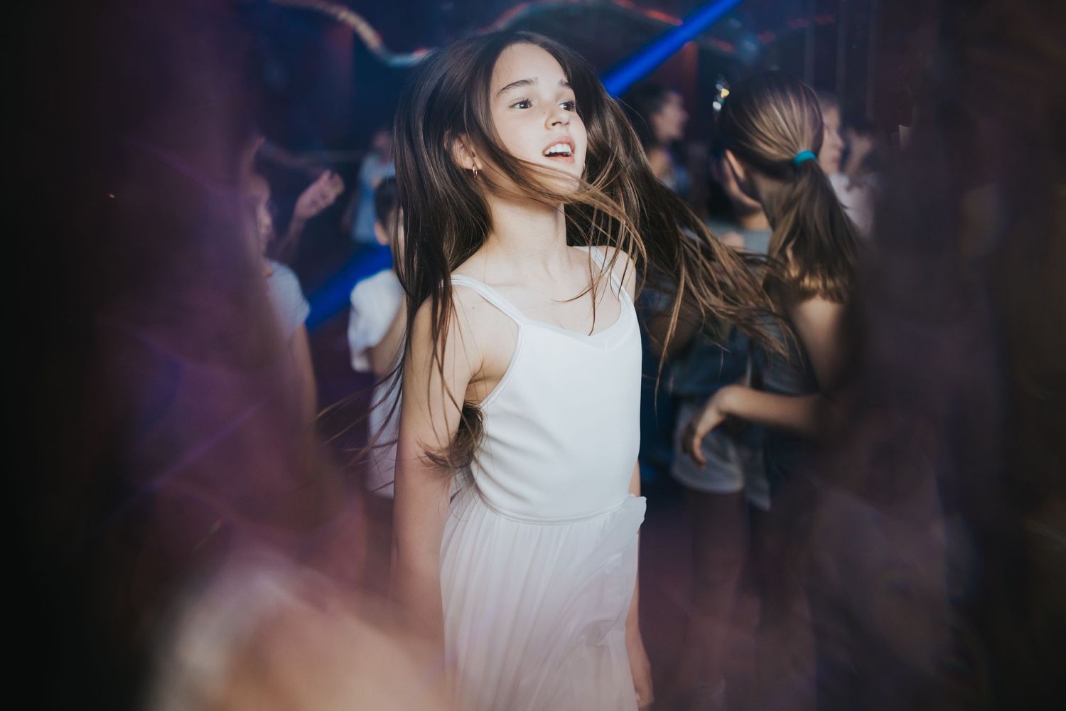 Ethereal dance party scene with flowing white dress and blue lighting effects.