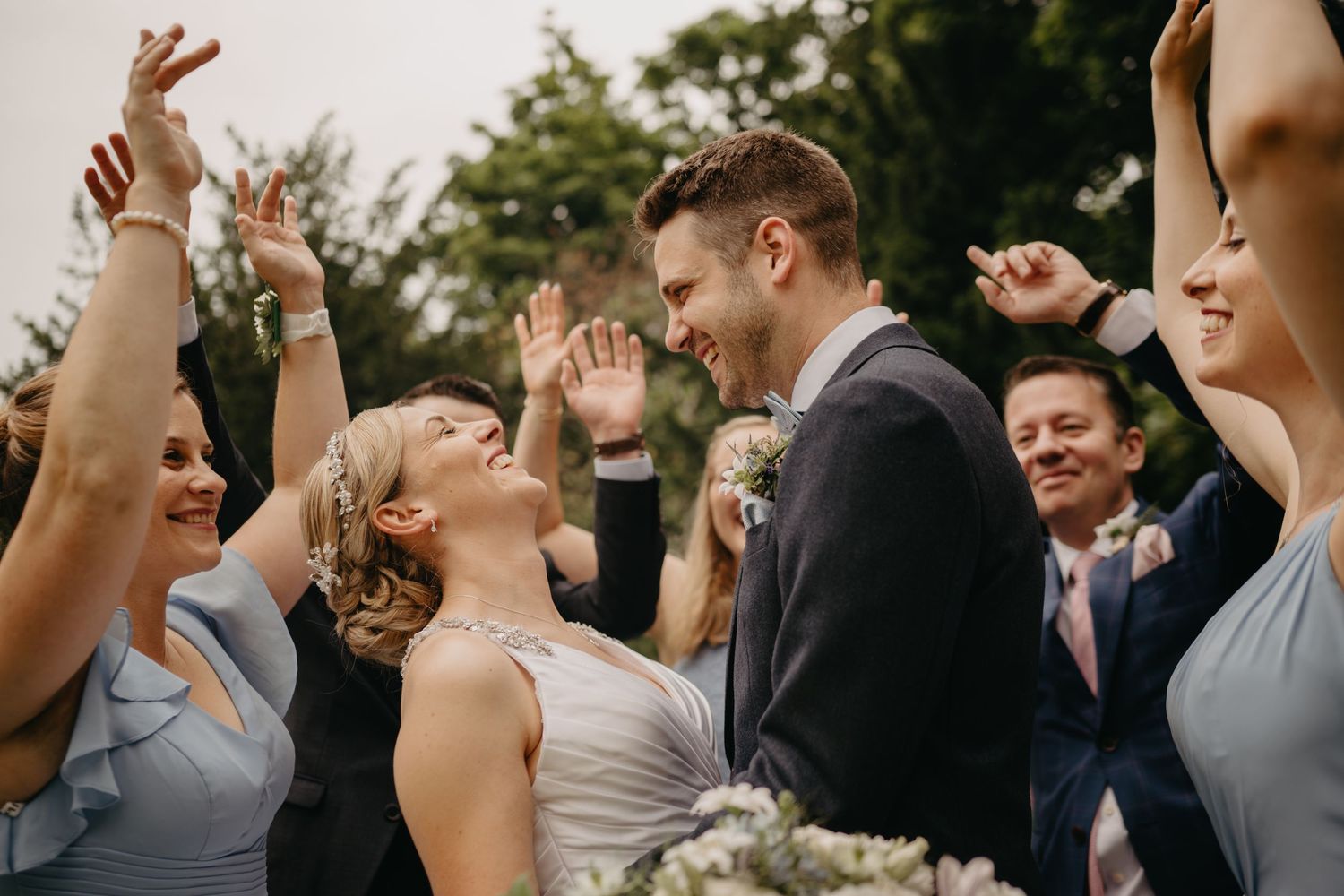 Bride, groom and wedding party celebrating during Scottish castle wedding.