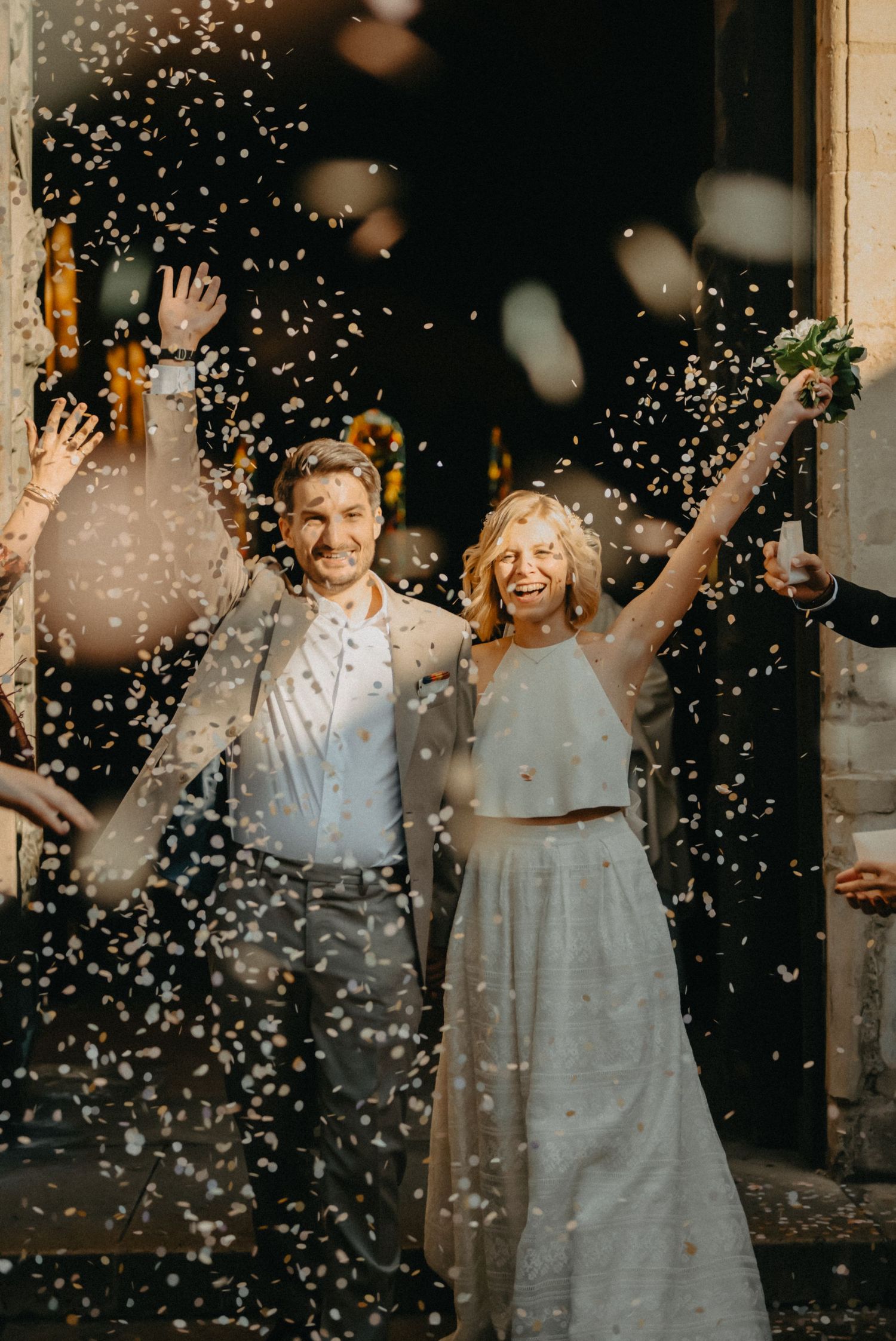 Bride and groom celebrating with confettis during destination wedding. in Paris, France.