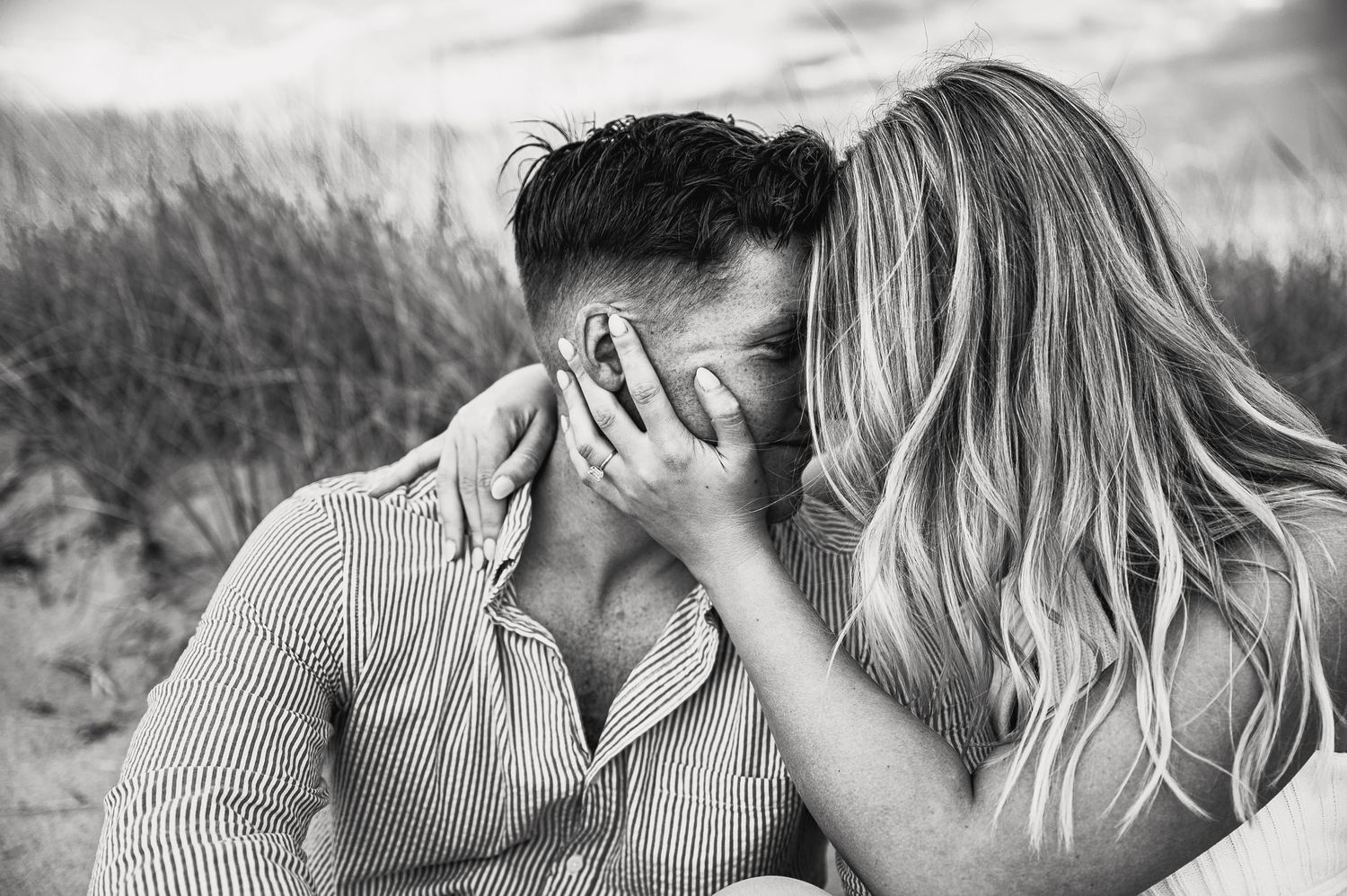 Intimate couple portrait session in black and white on a beach.