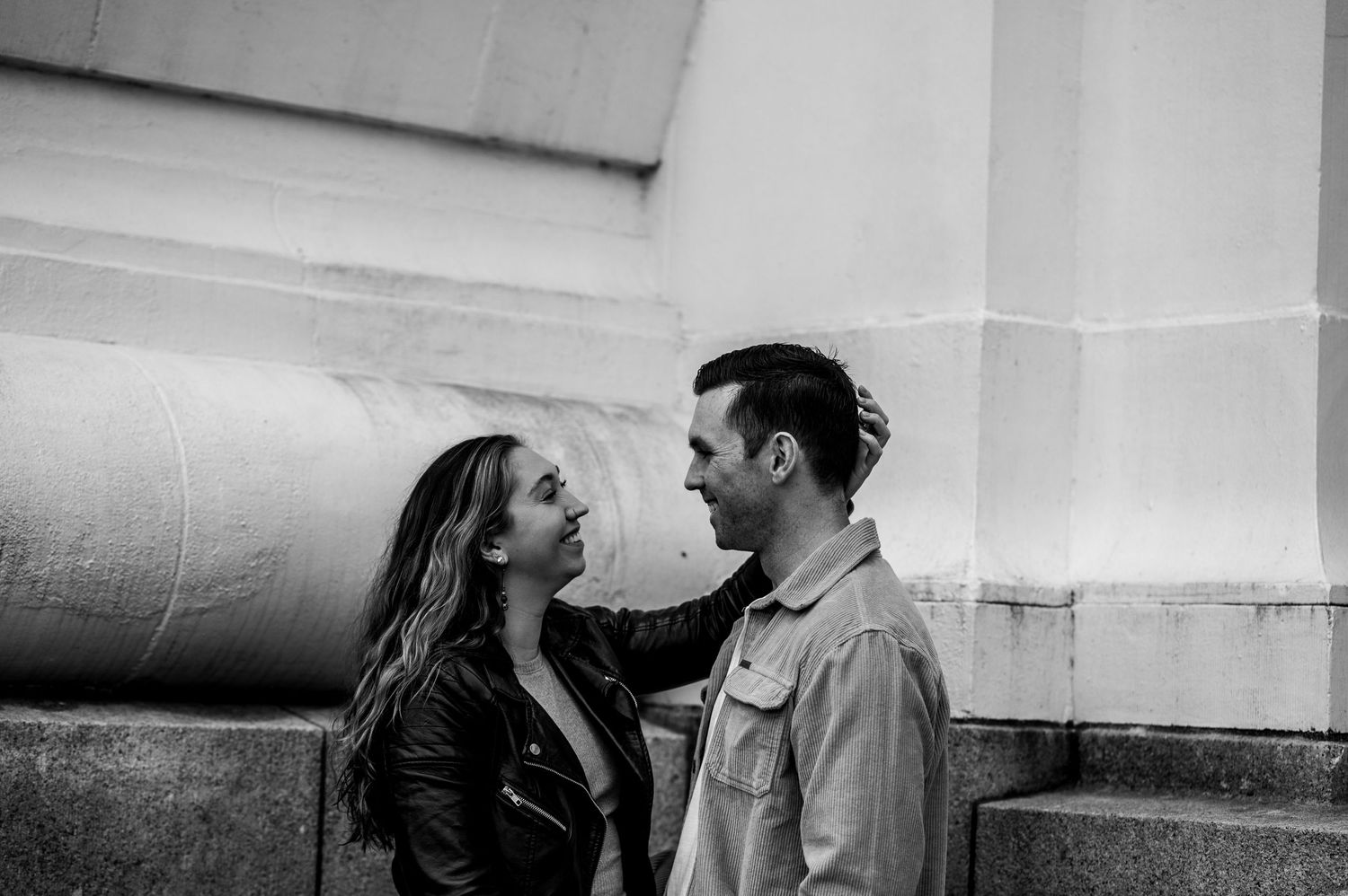 Romantic black and white photo series showing intimate moments between a couple on a beach at sunset.