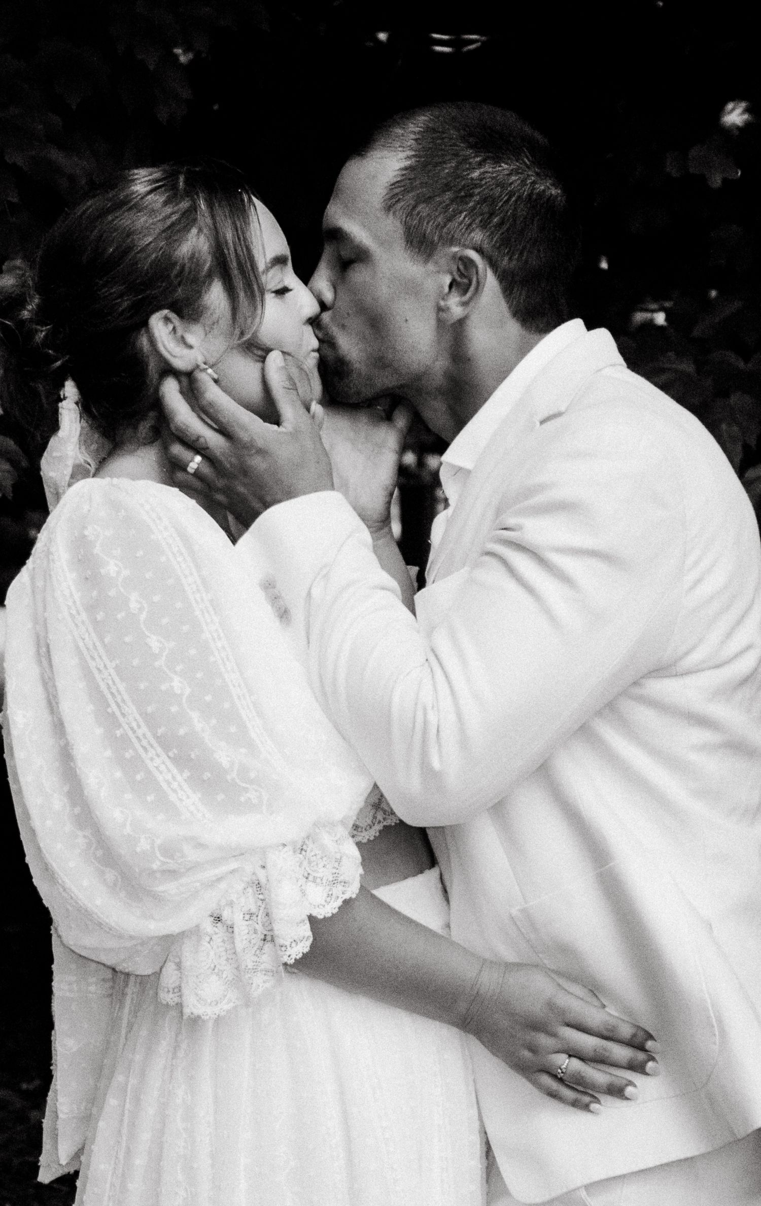 A series of romantic black and white photos showing an intimate embrace between a couple in white attire.