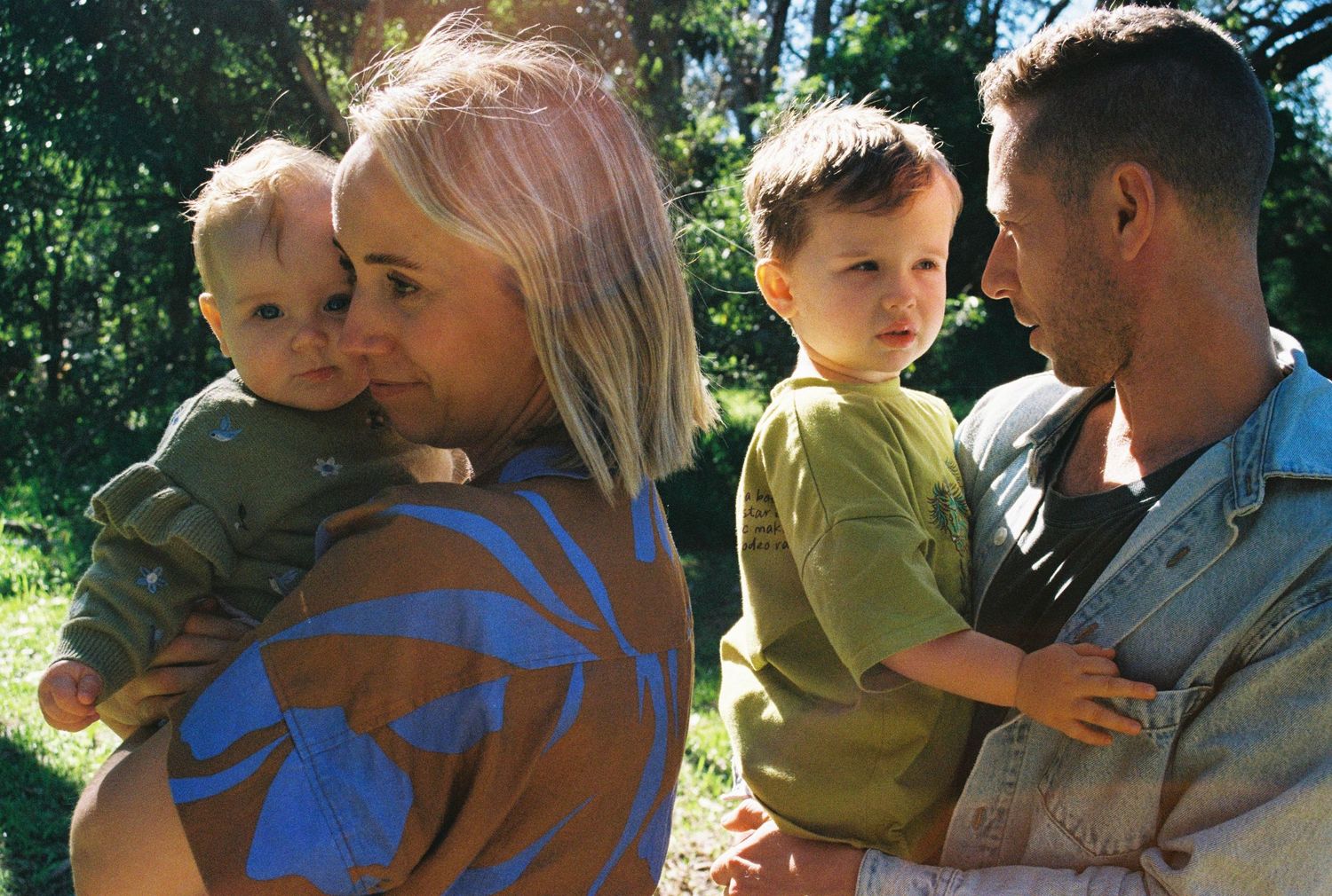 A family spends time together outdoors on a sunny day in a natural setting.