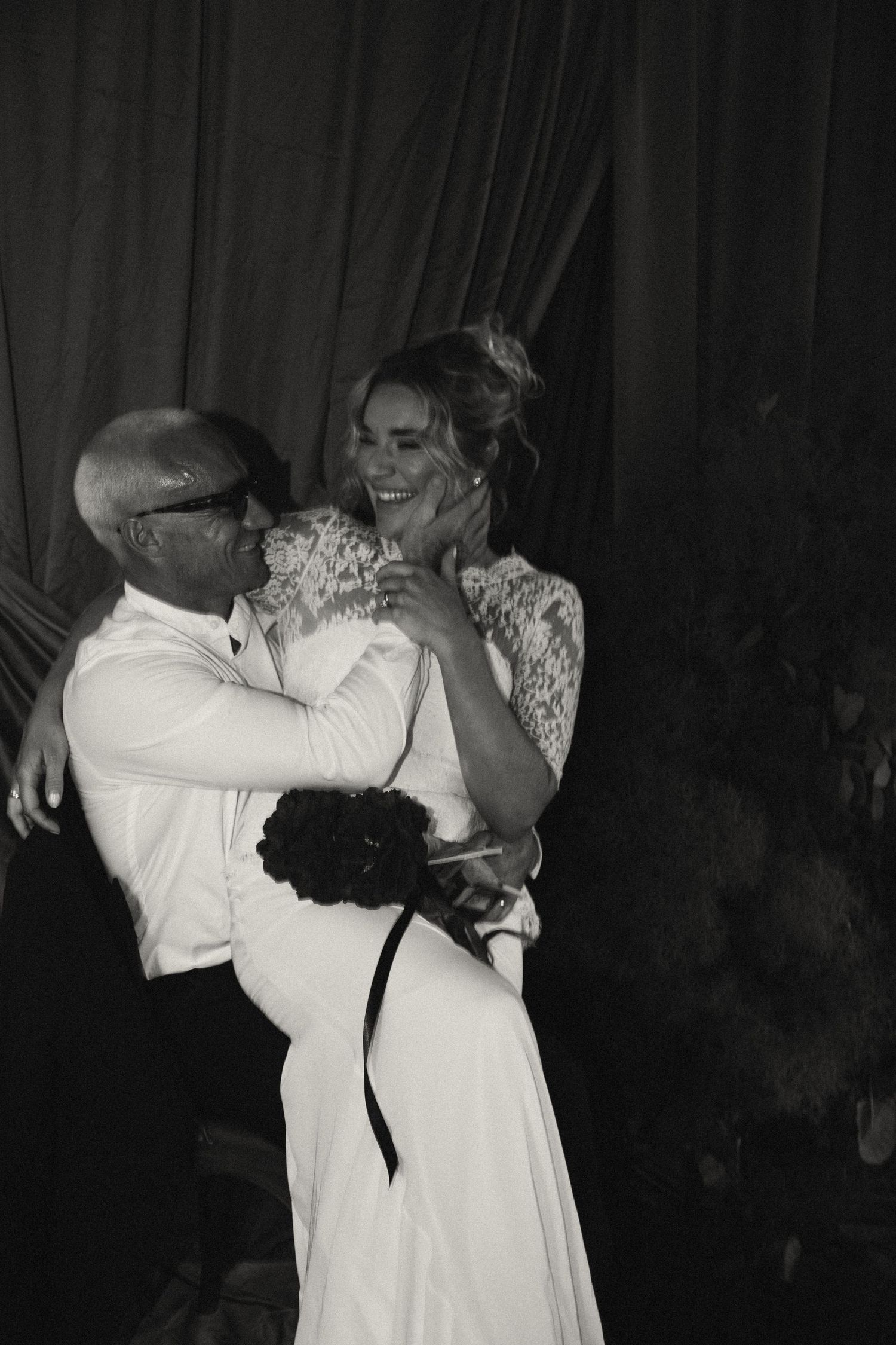 Intimate dance moment captured in black and white at wedding reception.