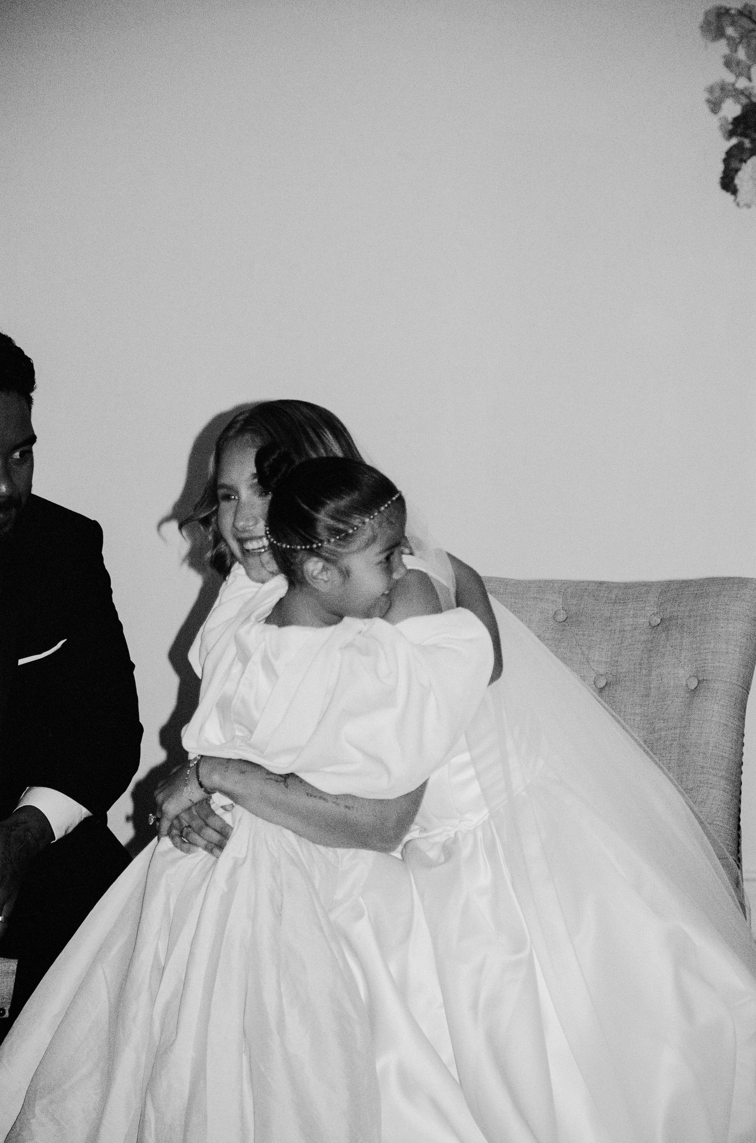 An intimate black and white wedding portrait showing a tender embrace.