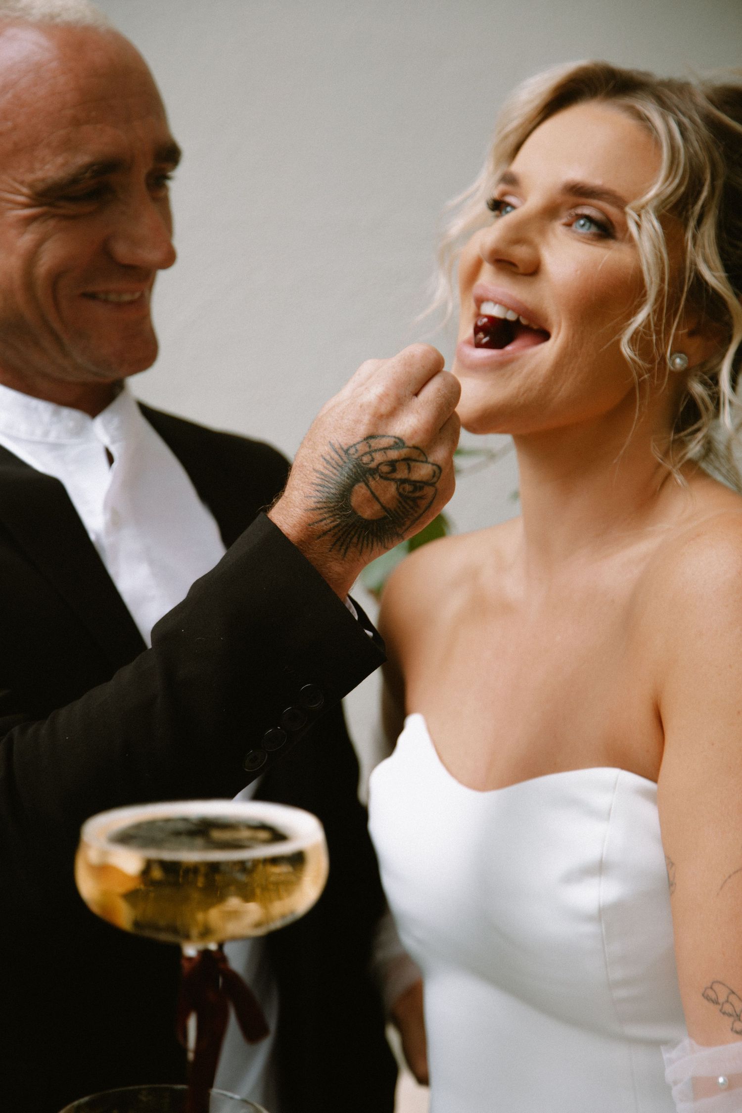 Happy wedding moment with champagne glasses and laughter.