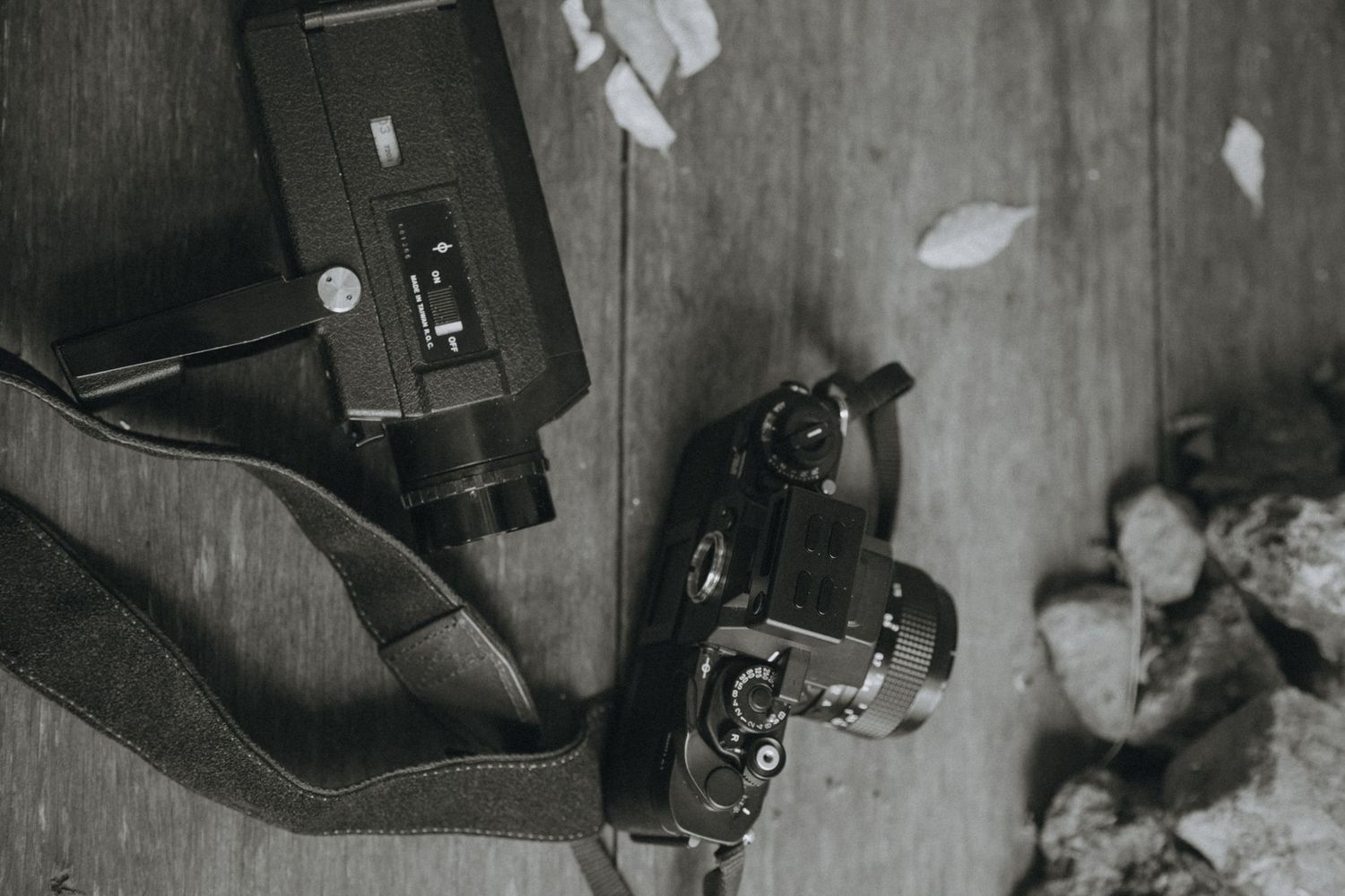 A monochrome filtered collage of cowboy boots, revolvers, and playing cards arranged in a western theme pattern.