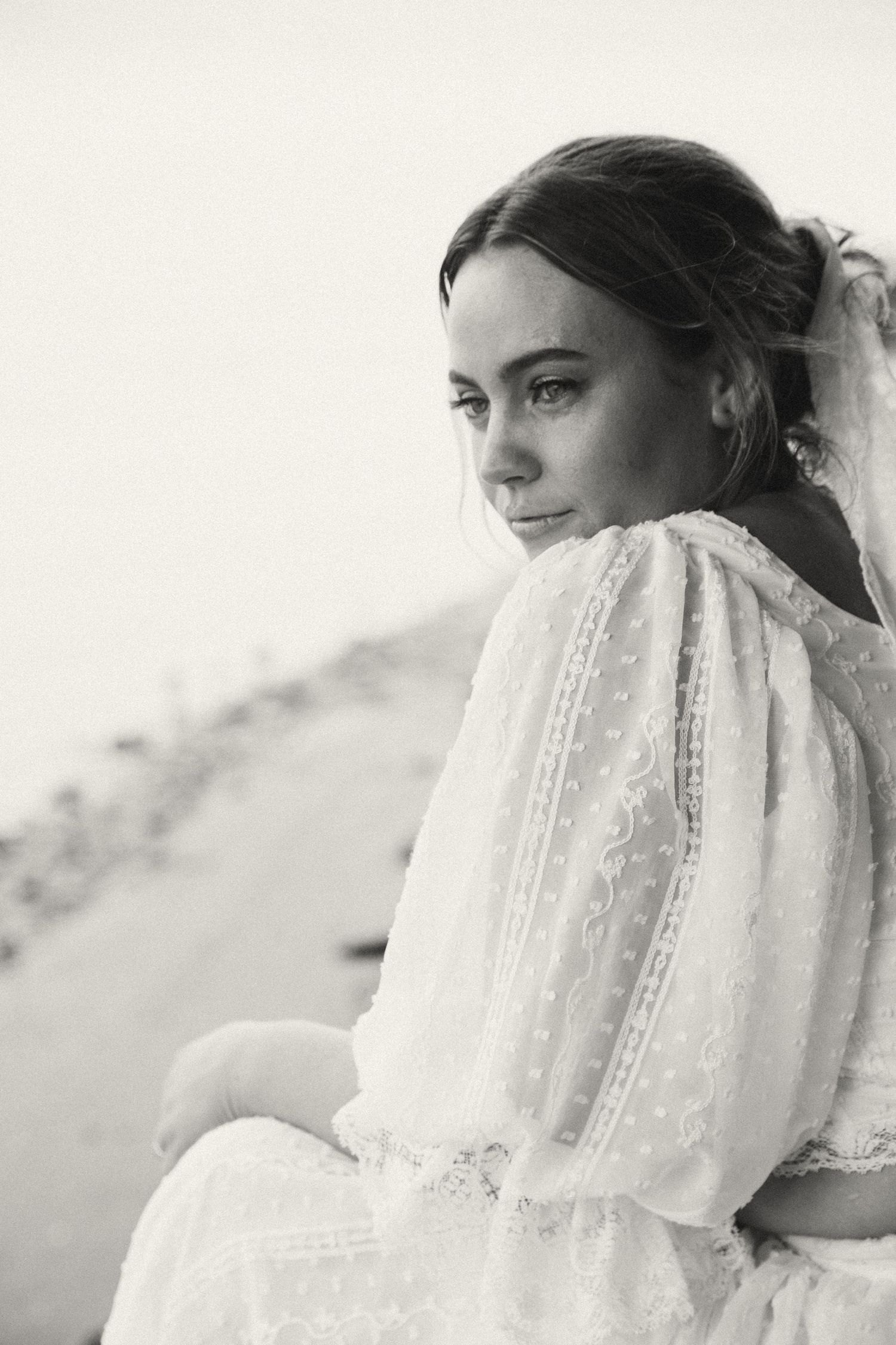 A delicate white veil blows in the breeze in this artistic black and white portrait sequence.