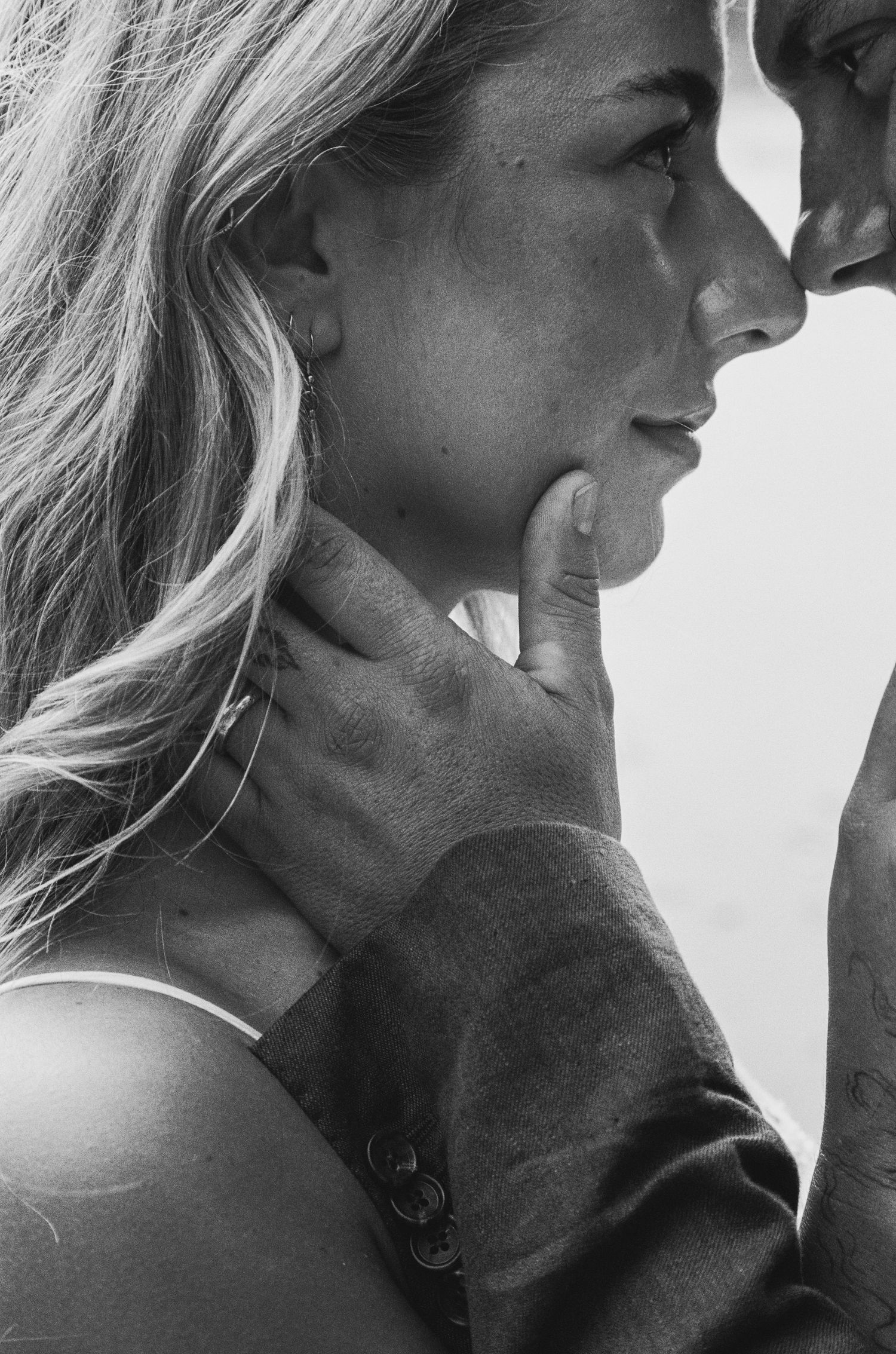 An intimate black and white close-up portrait capturing a tender moment.