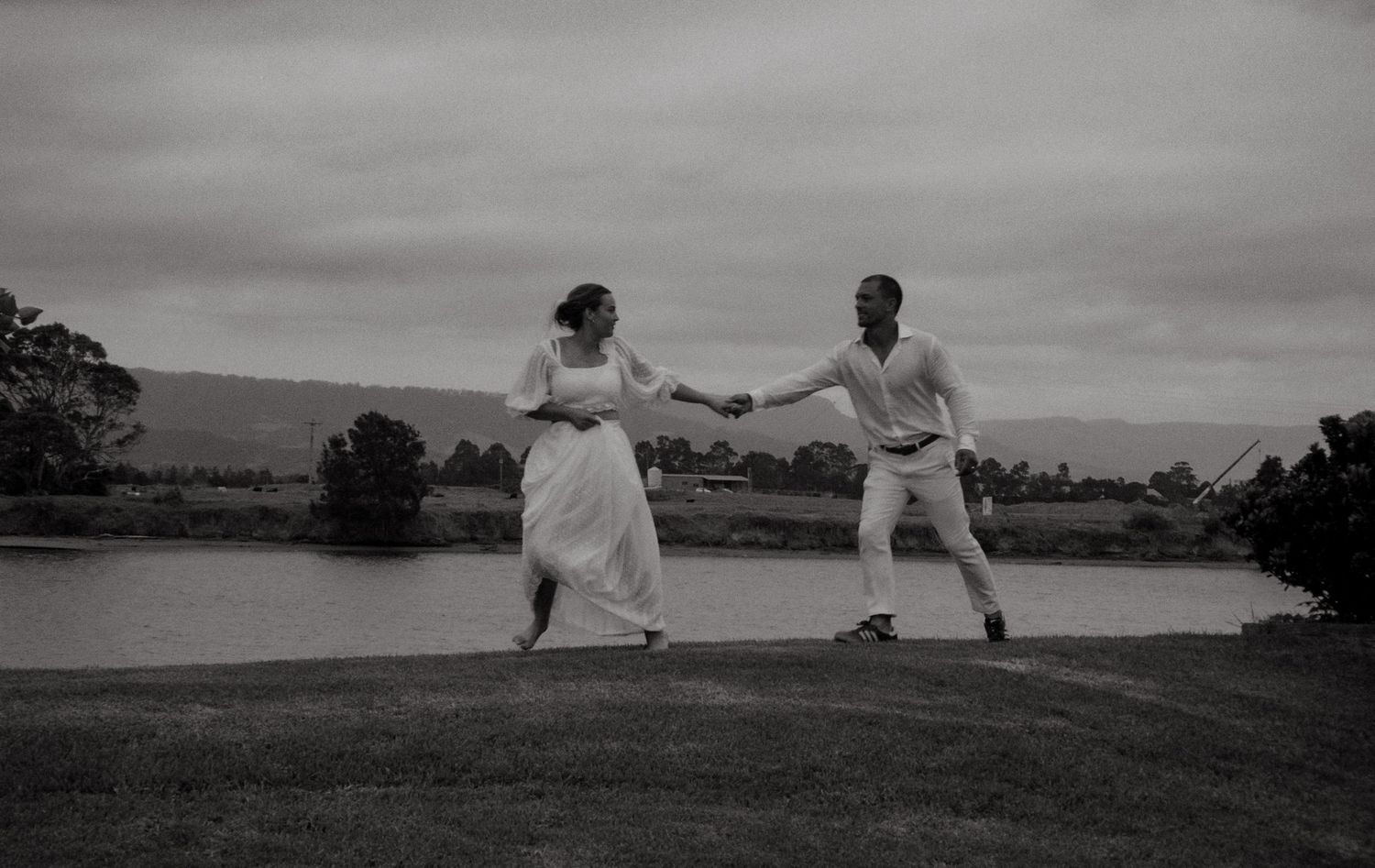A romantic black and white photo sequence shows a couple enjoying a playful spin dance in a grassy outdoor setting.