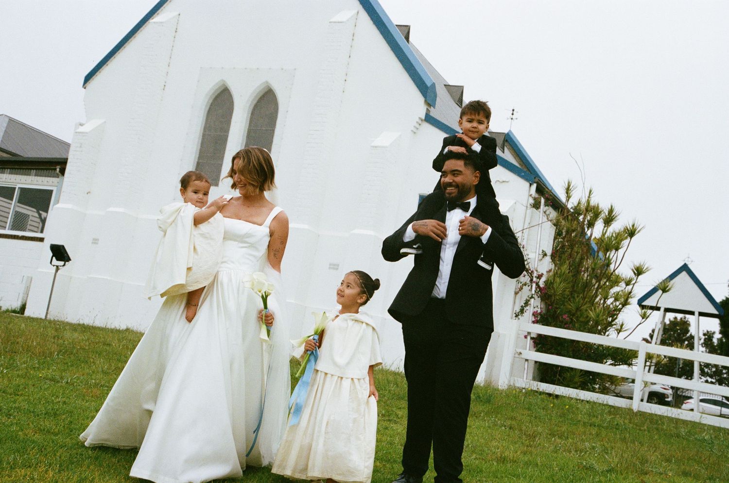 A series of candid wedding moments captured outdoors with people dancing and celebrating on a grassy lawn.