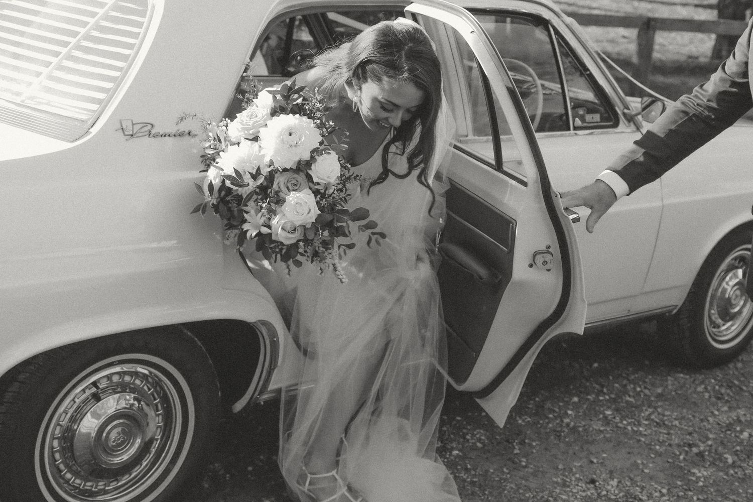 A black and white photo collage shows several vintage wedding scenes with couples entering classic cars.