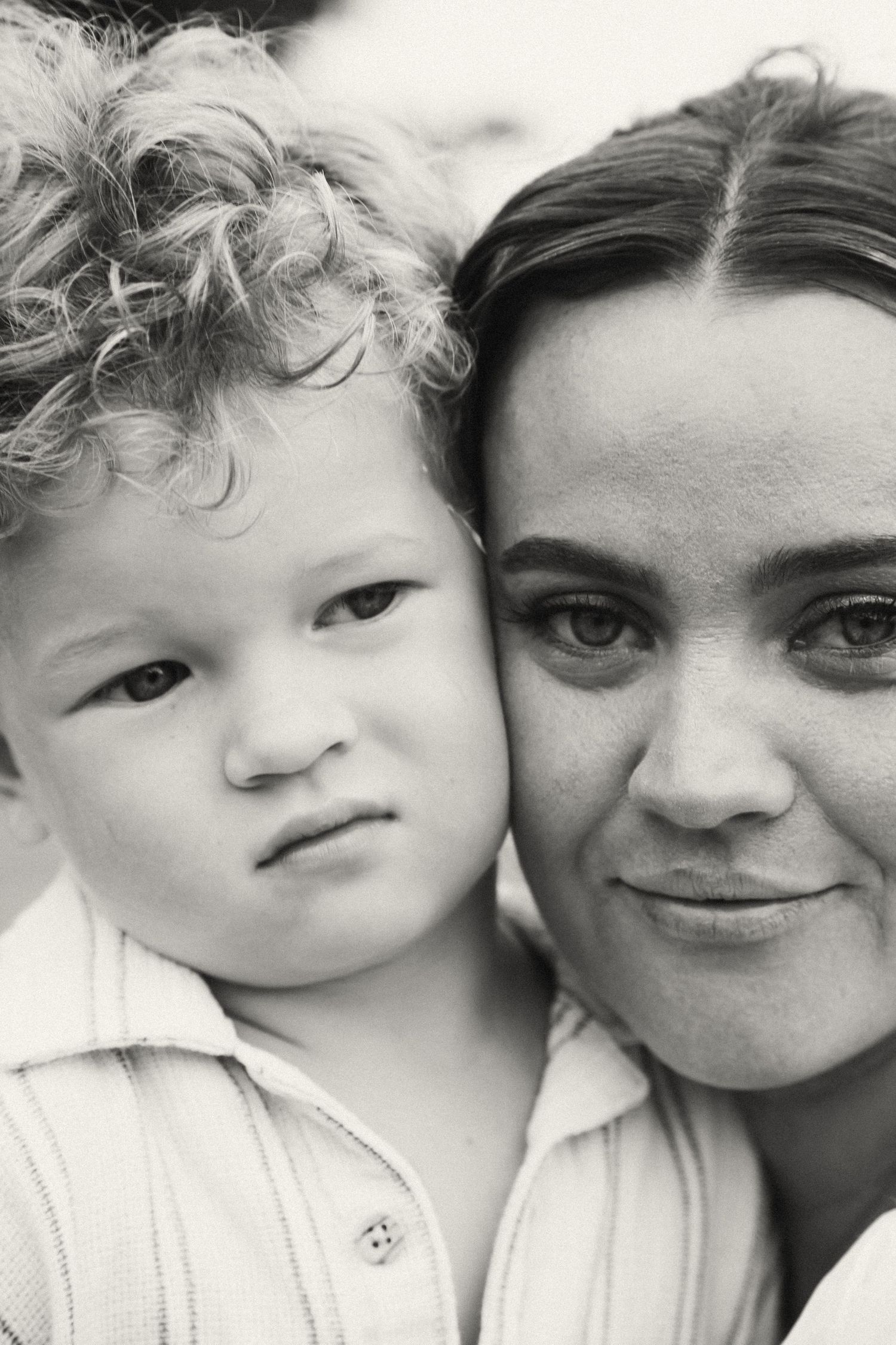 A series of black and white close-up portraits showing tender moments between two people.