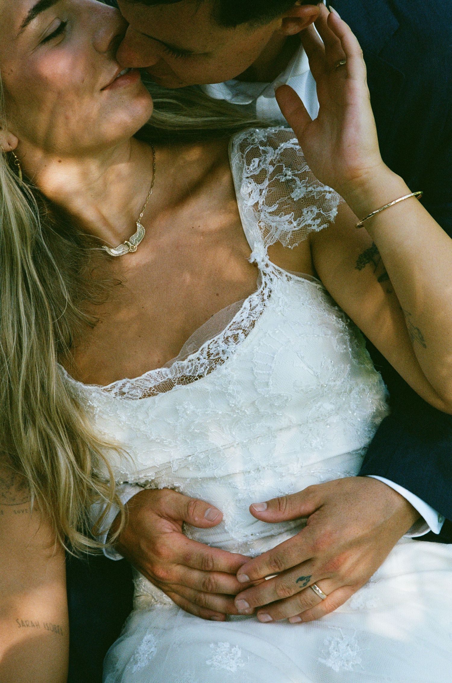 Close-up series showing delicate white lace details of a wedding dress bodice.