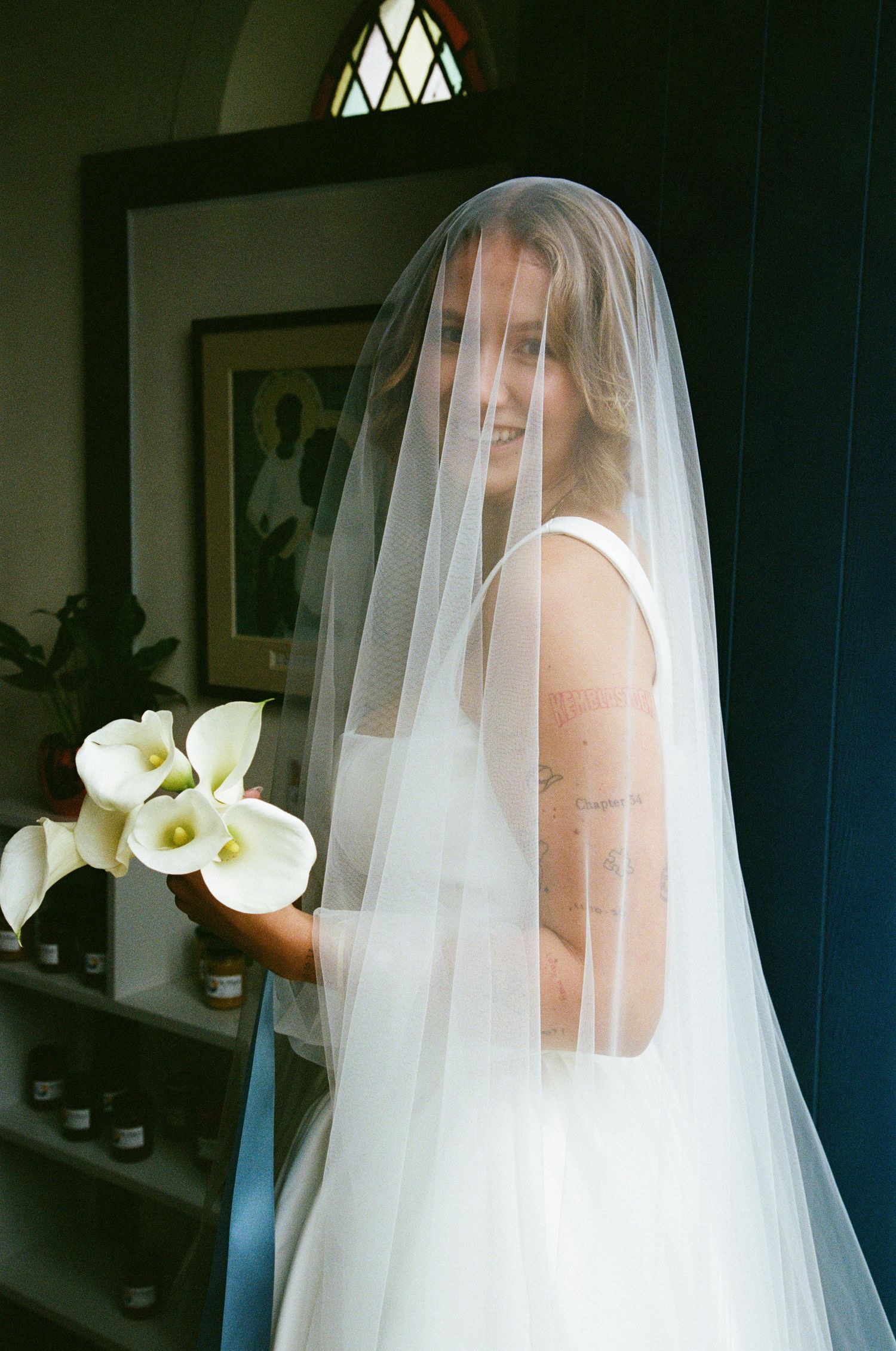 Ethereal bridal portraits with white calla lilies and delicate veil details.