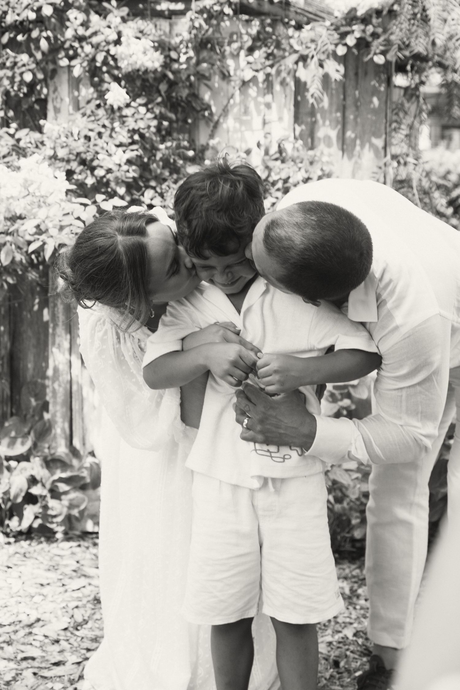 Black and white sequence showing couples bending forward in synchronized motion wearing white clothing.