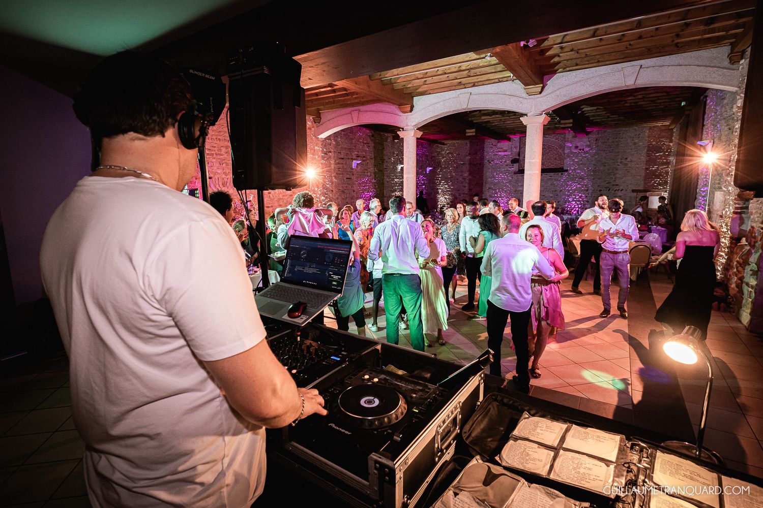 Colorful dance party scene with DJ booth and lighting effects.