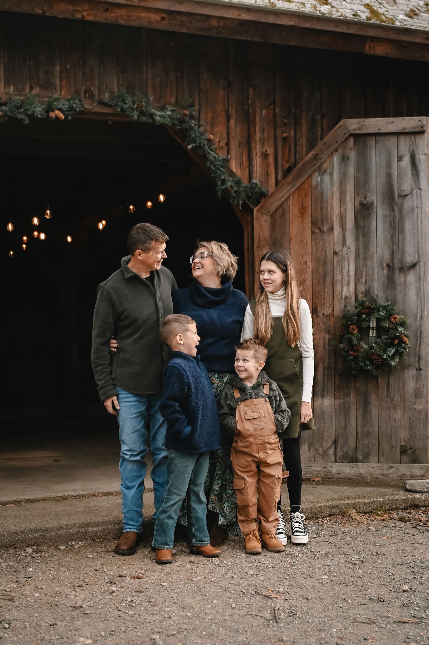 Family photography session in Sturbridge MA featuring family standing next to barn.