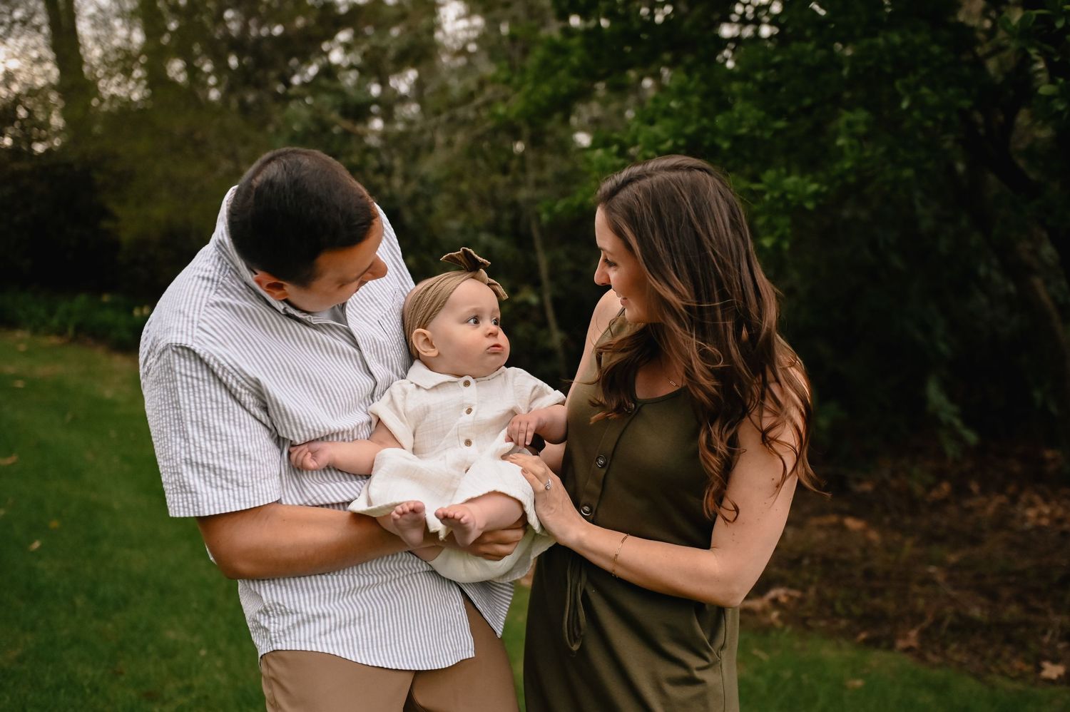 Worcester newborn photography session featuring  man and woman holding baby smiling.