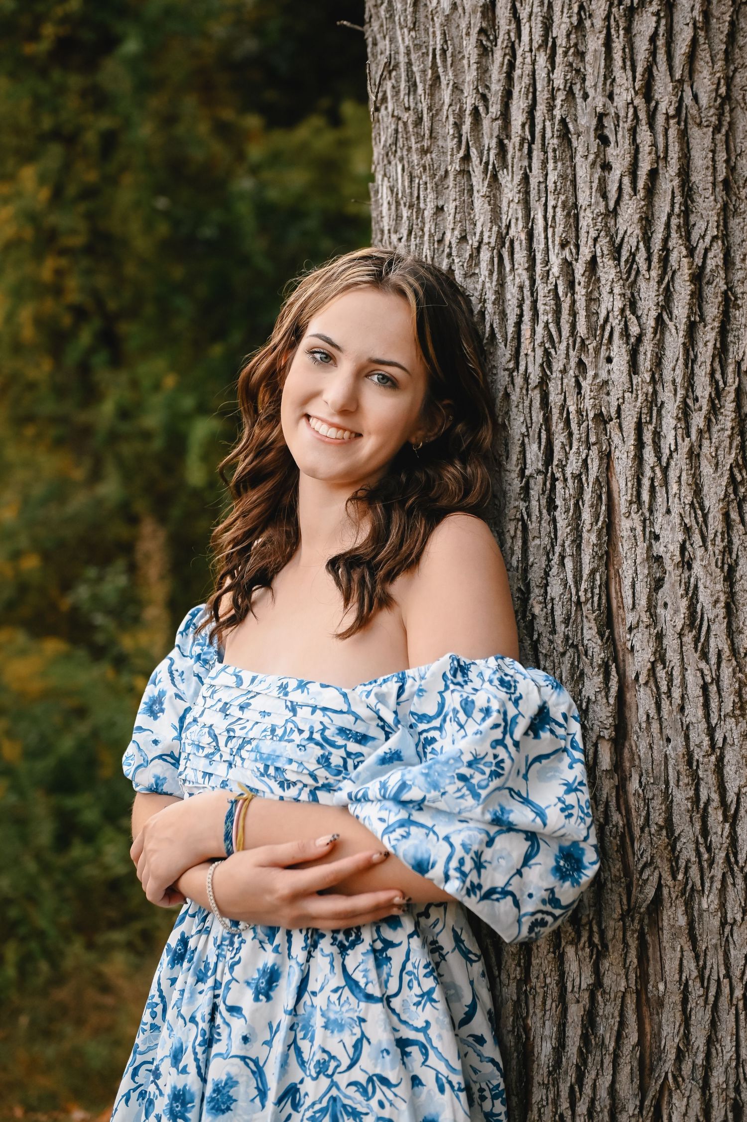 Senior portraits photographer featuring young woman in blue dress.