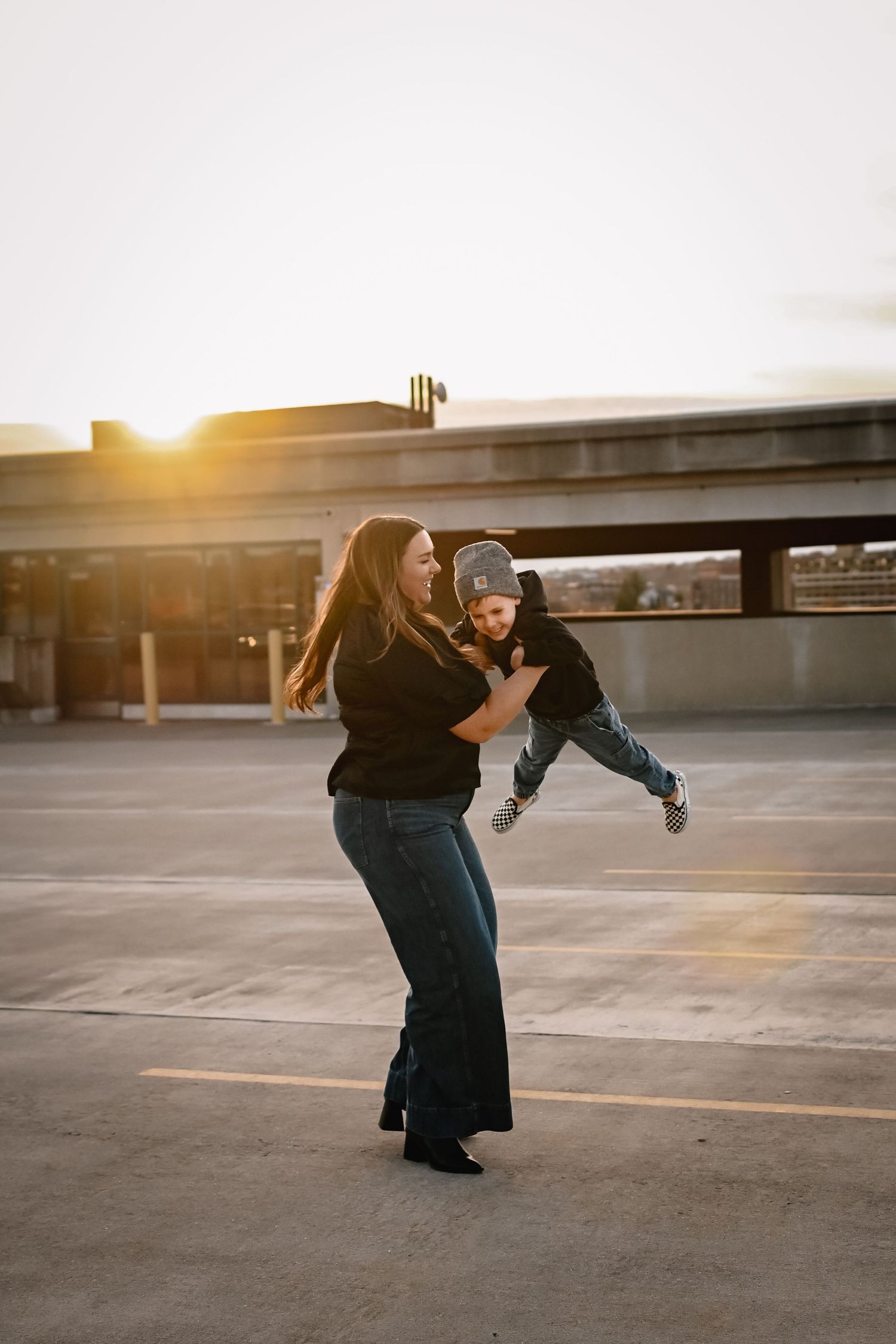 Auburn family photographer capturing moments with mom and sun outside.