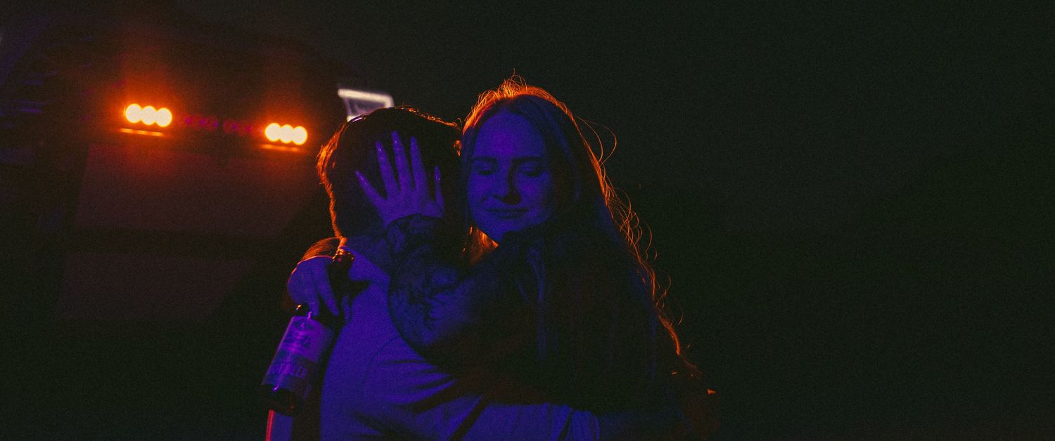 Cinematic couple photoshoot in Joshua Tree, California with dramatic blue light and truck headlights.