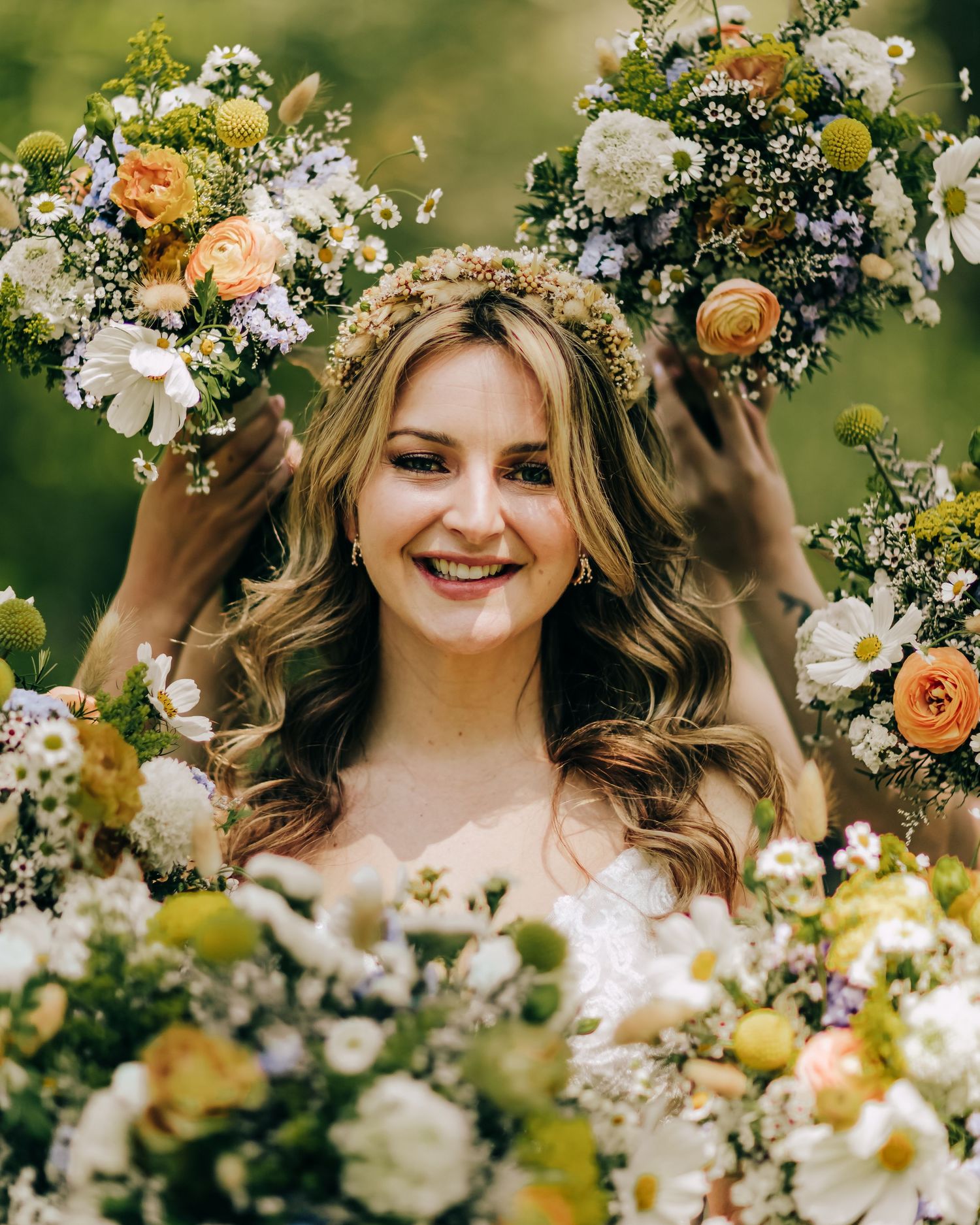 Beautiful bride surrounded by her bridesmaid's bouquets as well as her own to show off the color palette of her wedding
