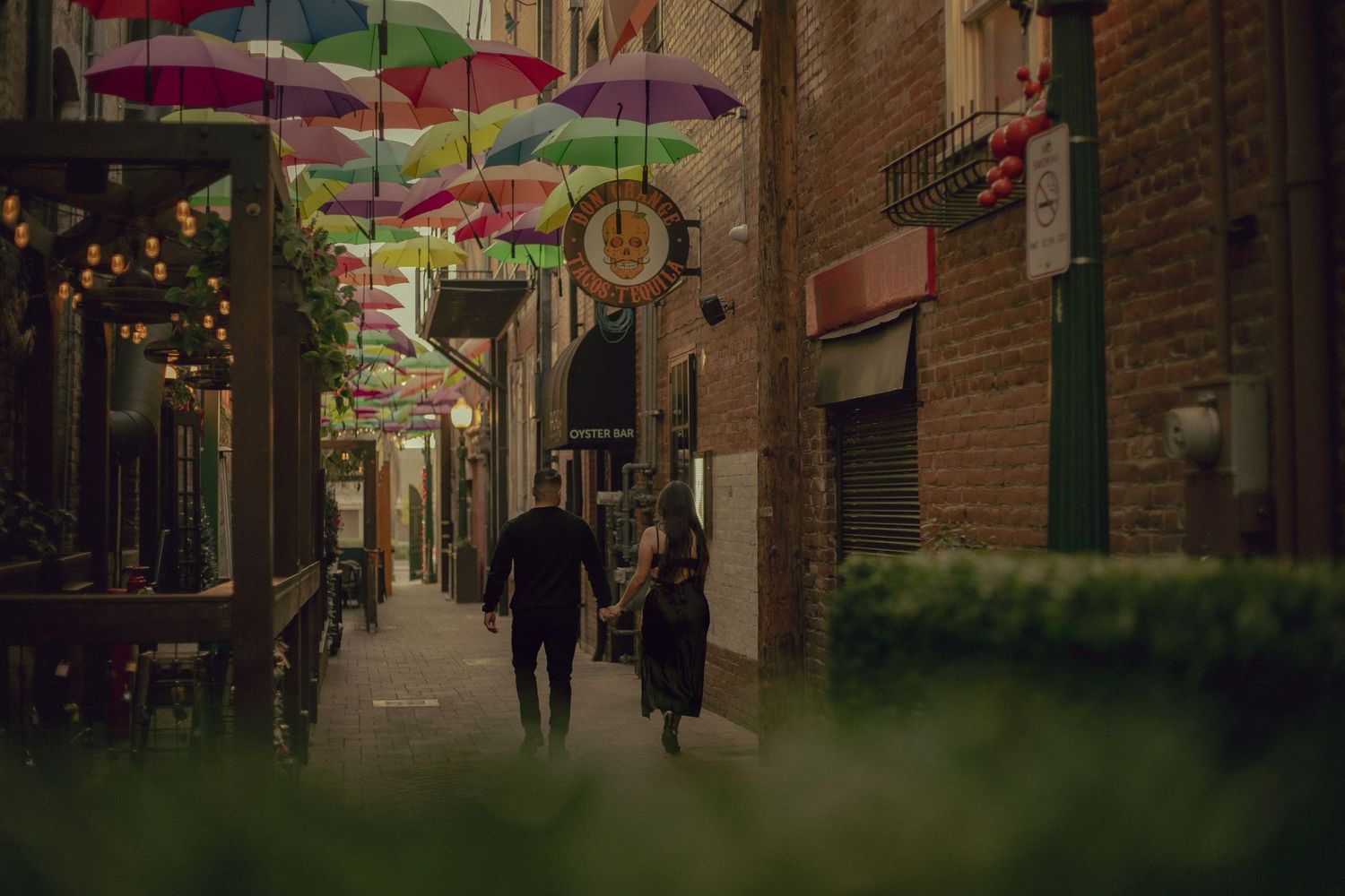 Cinematic Photography session of couple walking through the famous Orange Street Alley in Redlands behind the Don Orange restaurant.