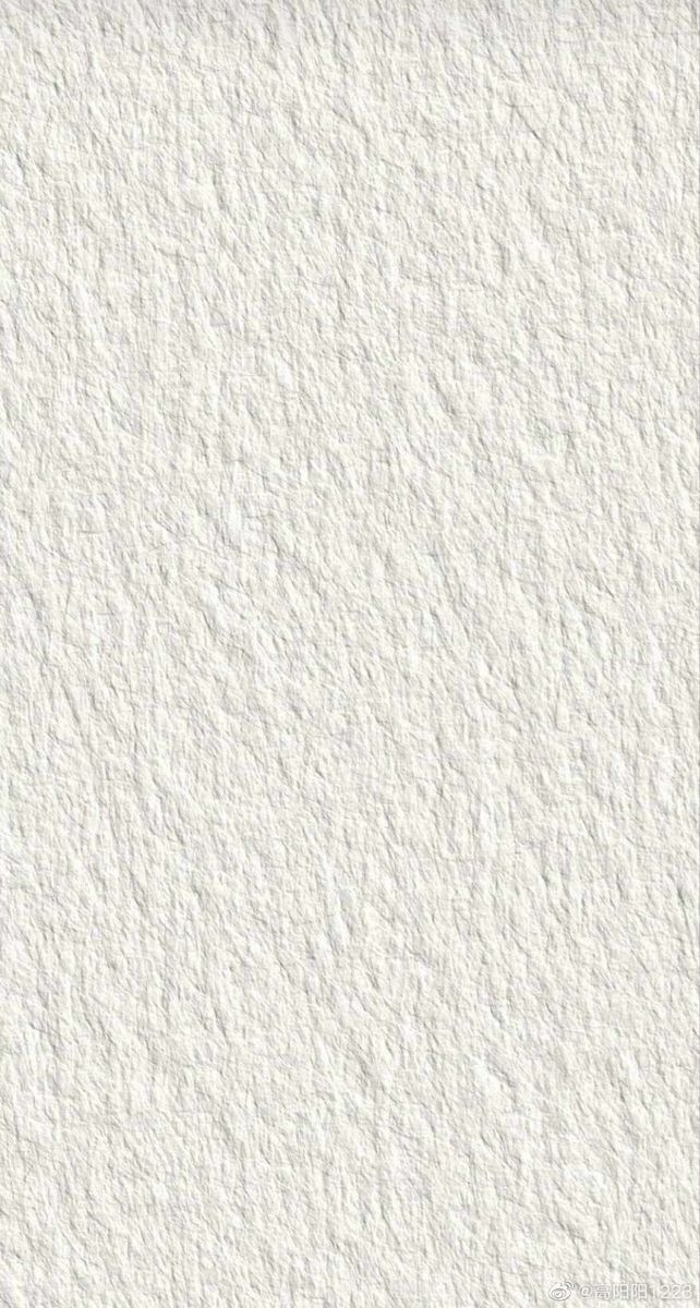 A white textured wall or surface with a rough, grainy pattern resembling stucco or plaster.