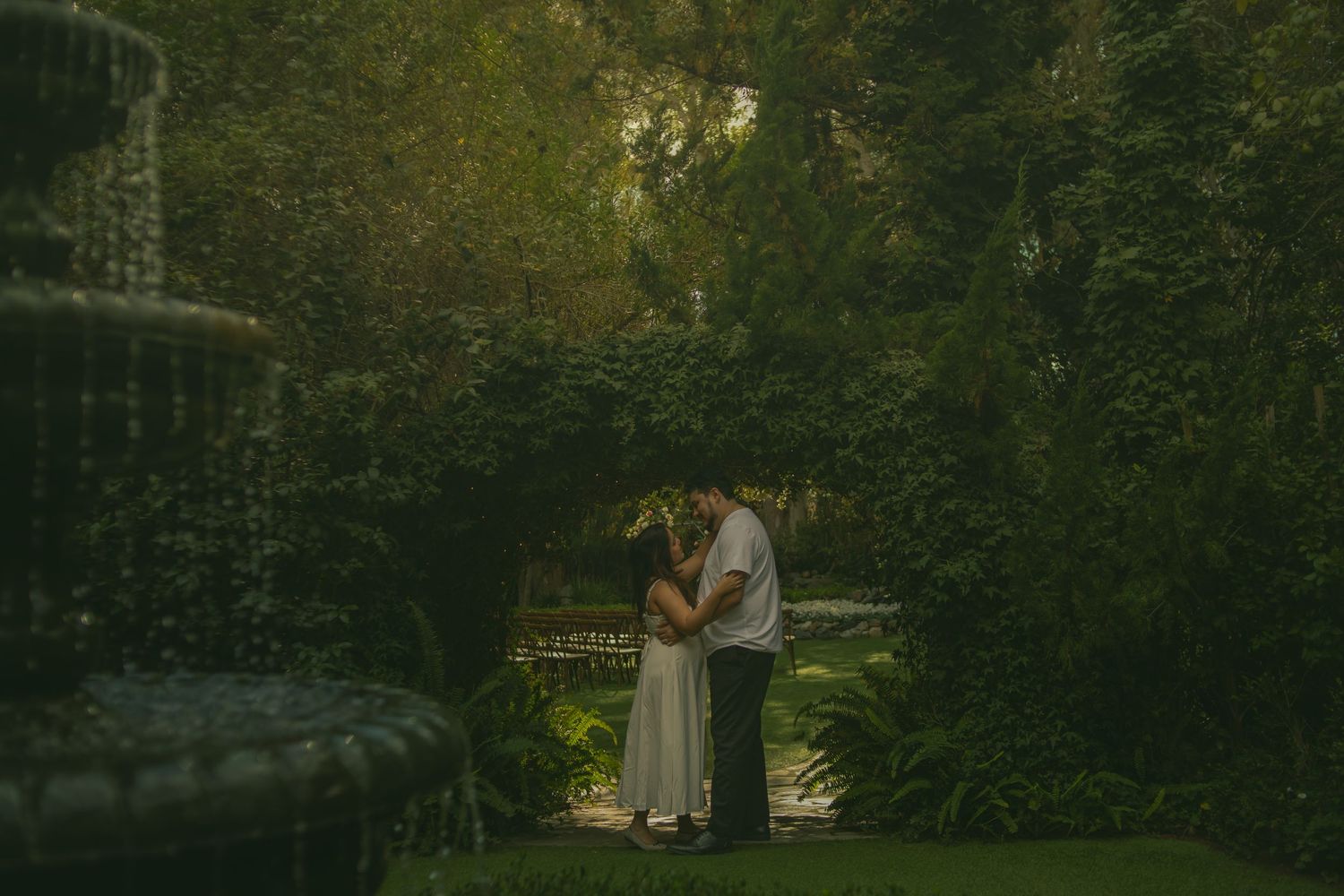 Cinematic storytelling engagement session of a romantic couple in the green gardens of the Twin Oaks Wedding Venue in San Marcos, California