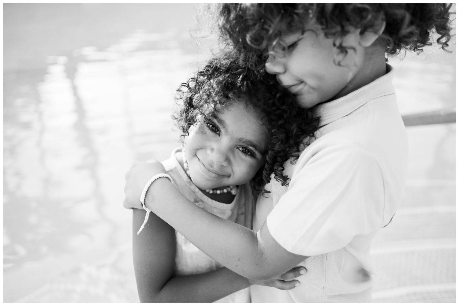 A series of intimate black and white photos showing tender embraces and affectionate moments.